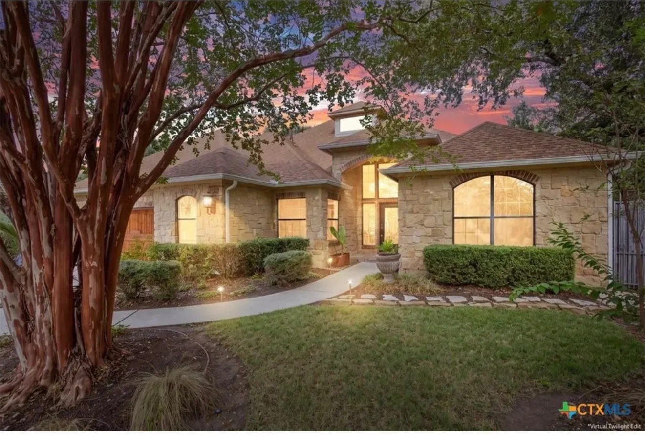 Twilight exterior of the single-story Mount Bonnell retreat at 5612 Bonnell Vista St in Austin, Texas