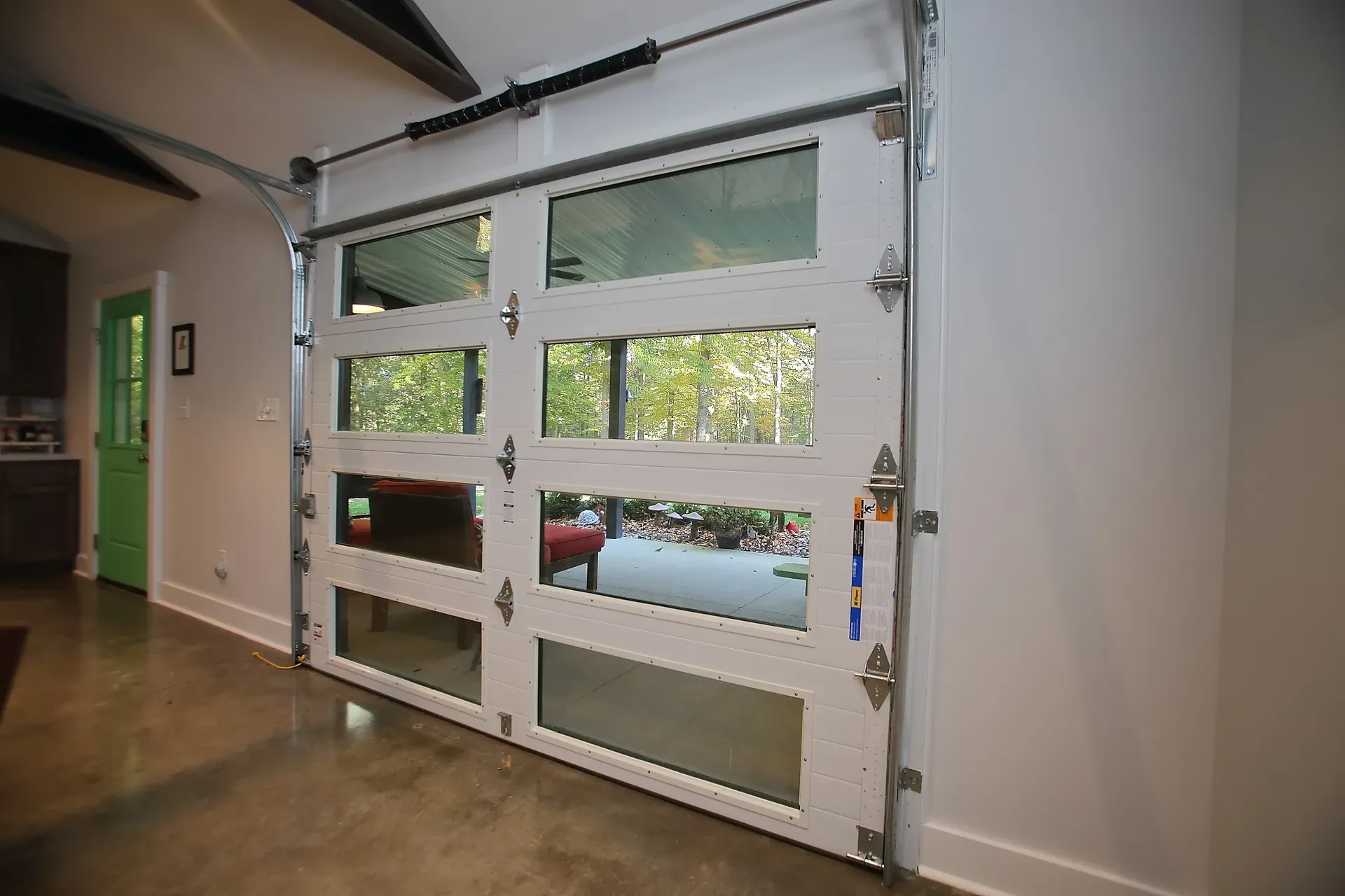Large glass-panel garage door letting daylight into the flex space
