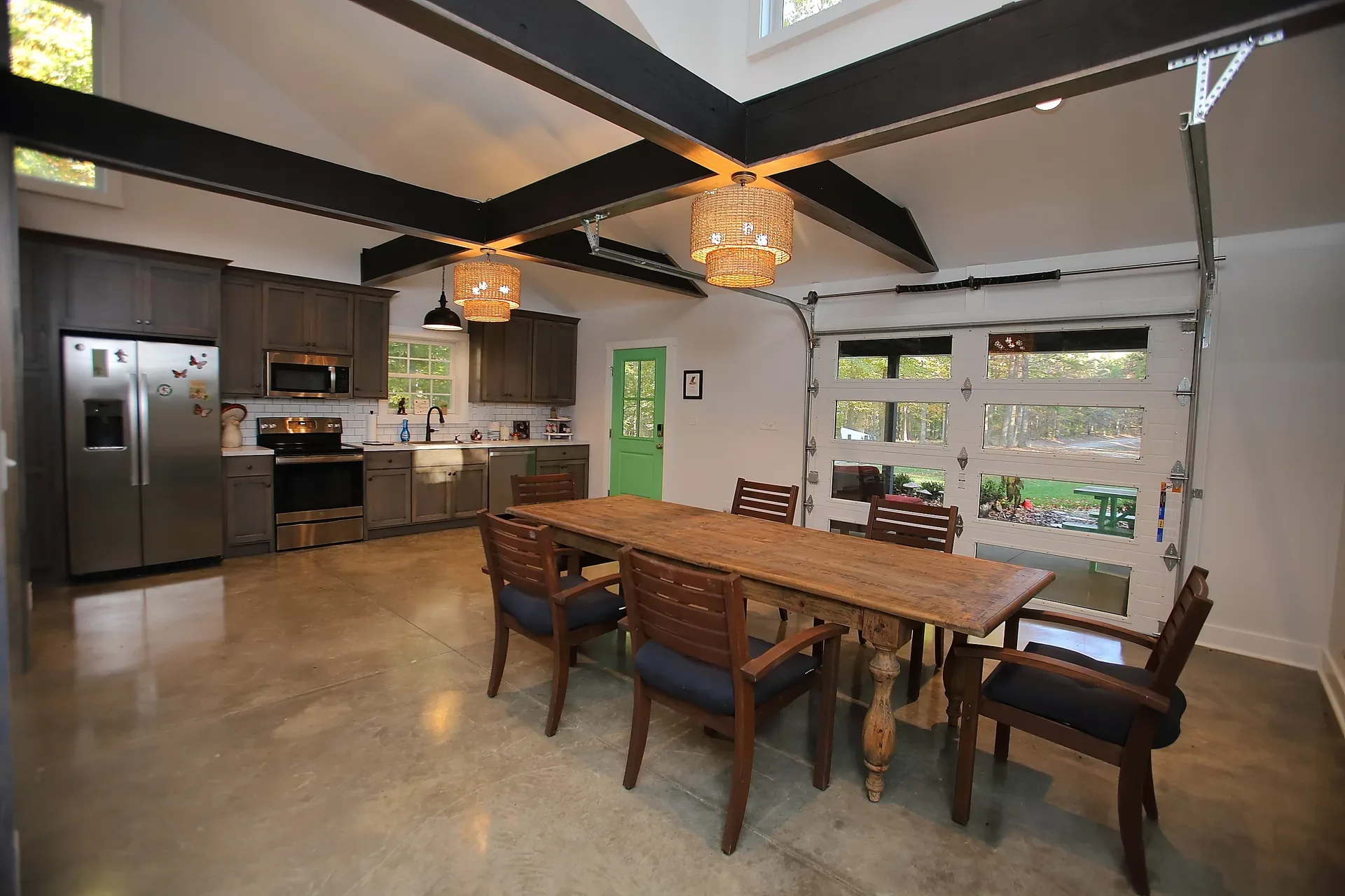 Kitchen and dining area with a wooden dining table and pendant lights
