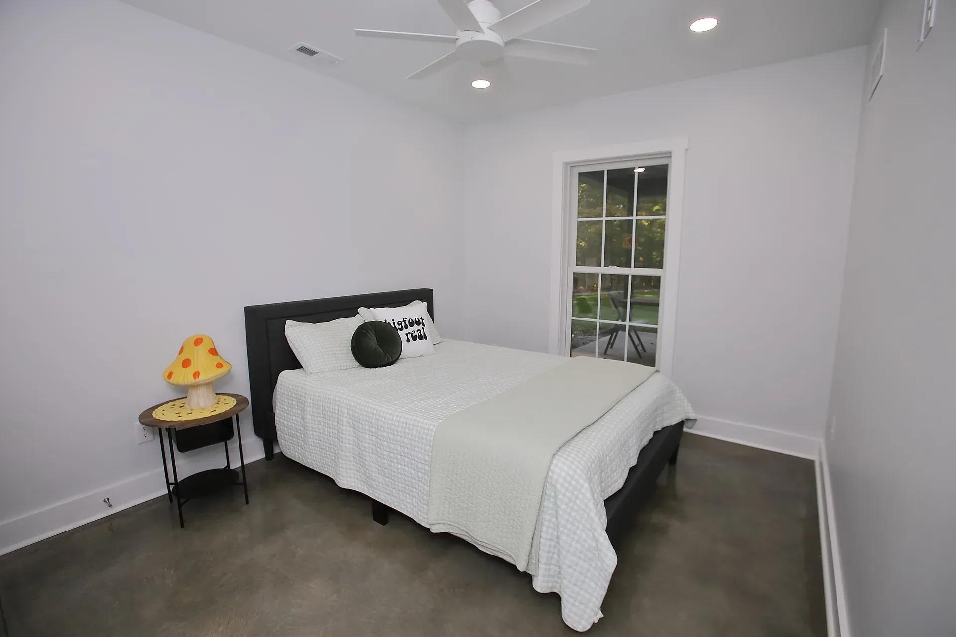 Second bedroom with a window overlooking the covered porch