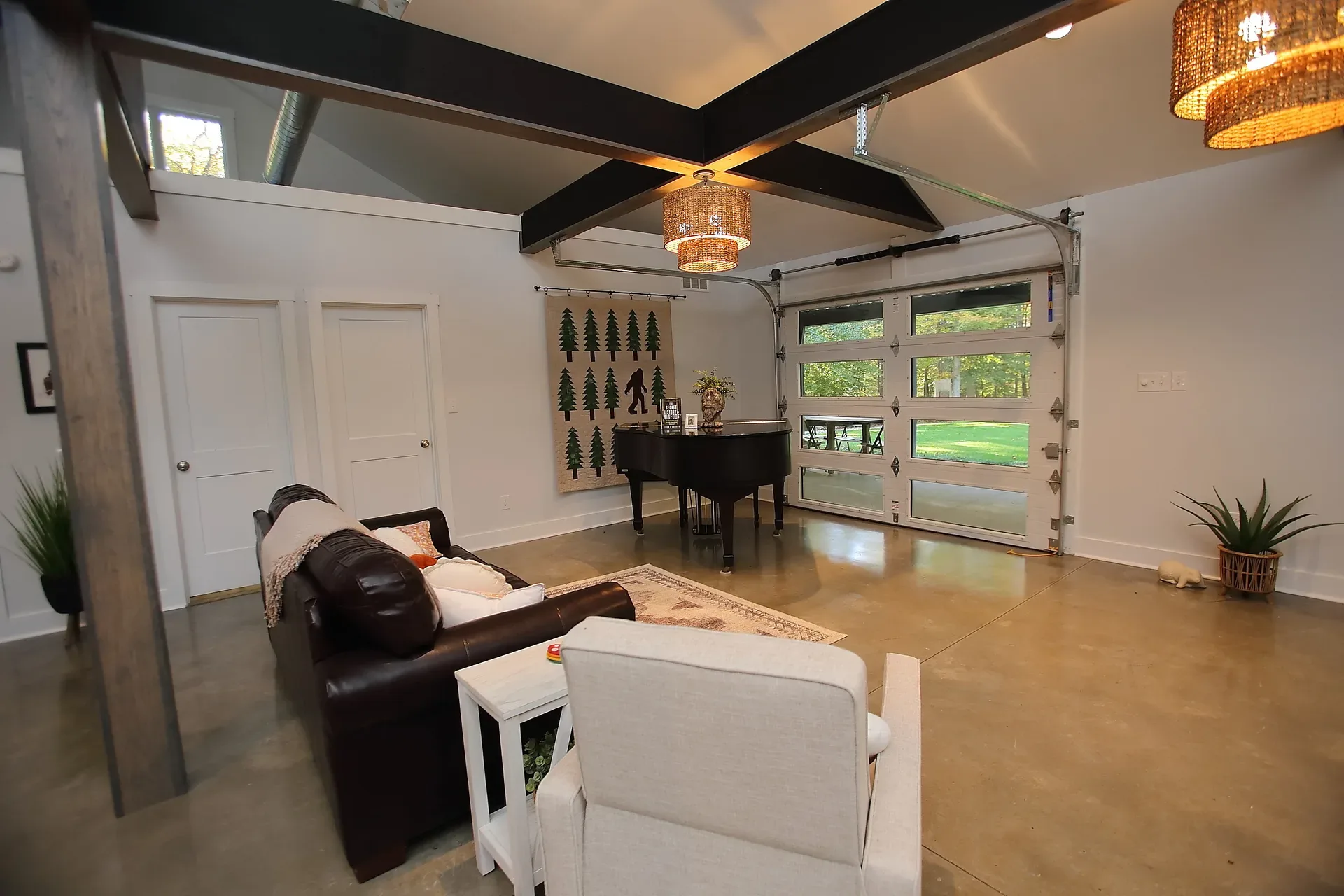 Living room flex space with a glass garage-style door opening to the porch