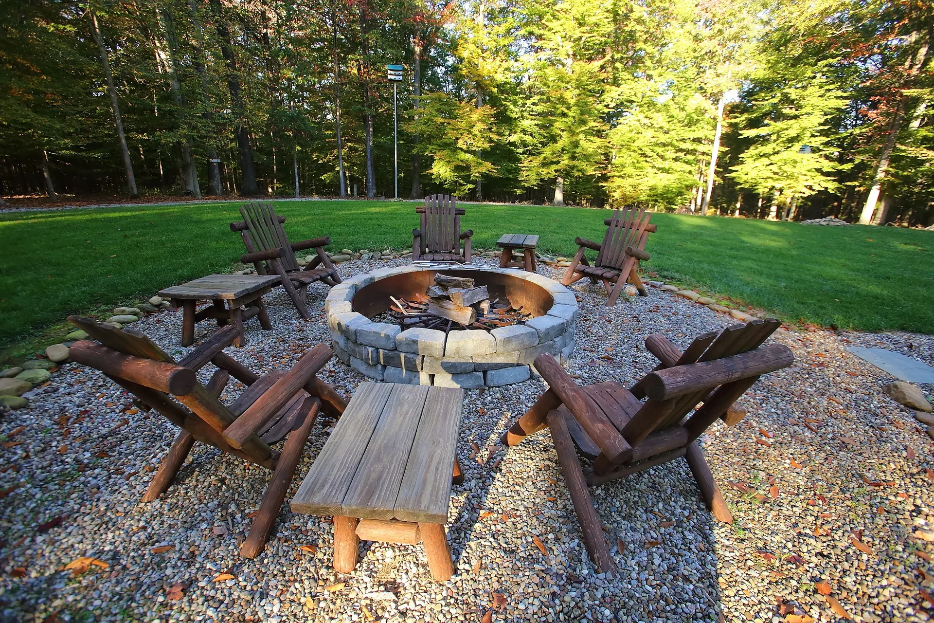 Gravel fire pit circle with Adirondack chairs