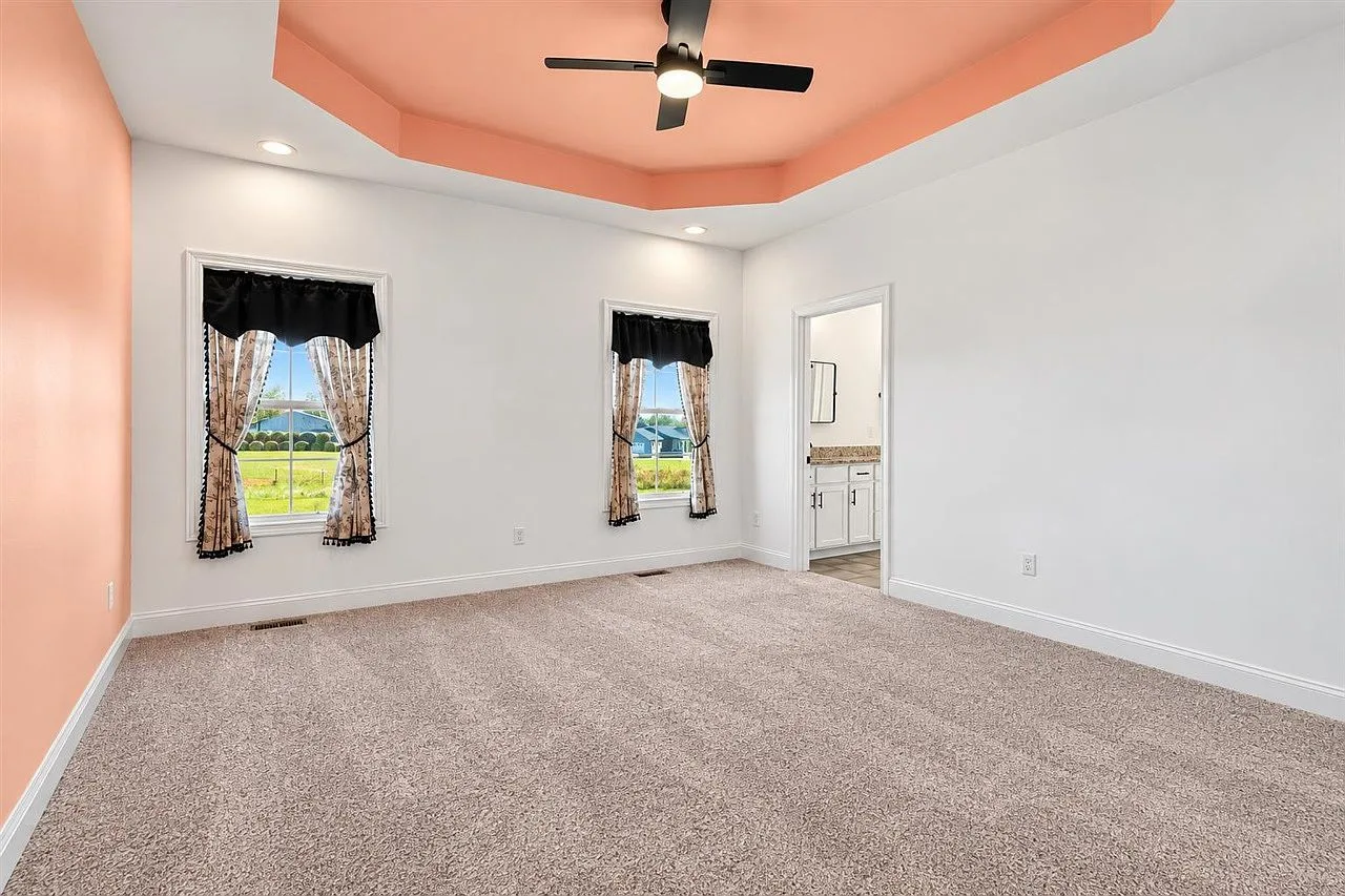 Primary bedroom with a tray ceiling at 87 Stone Trace Ct