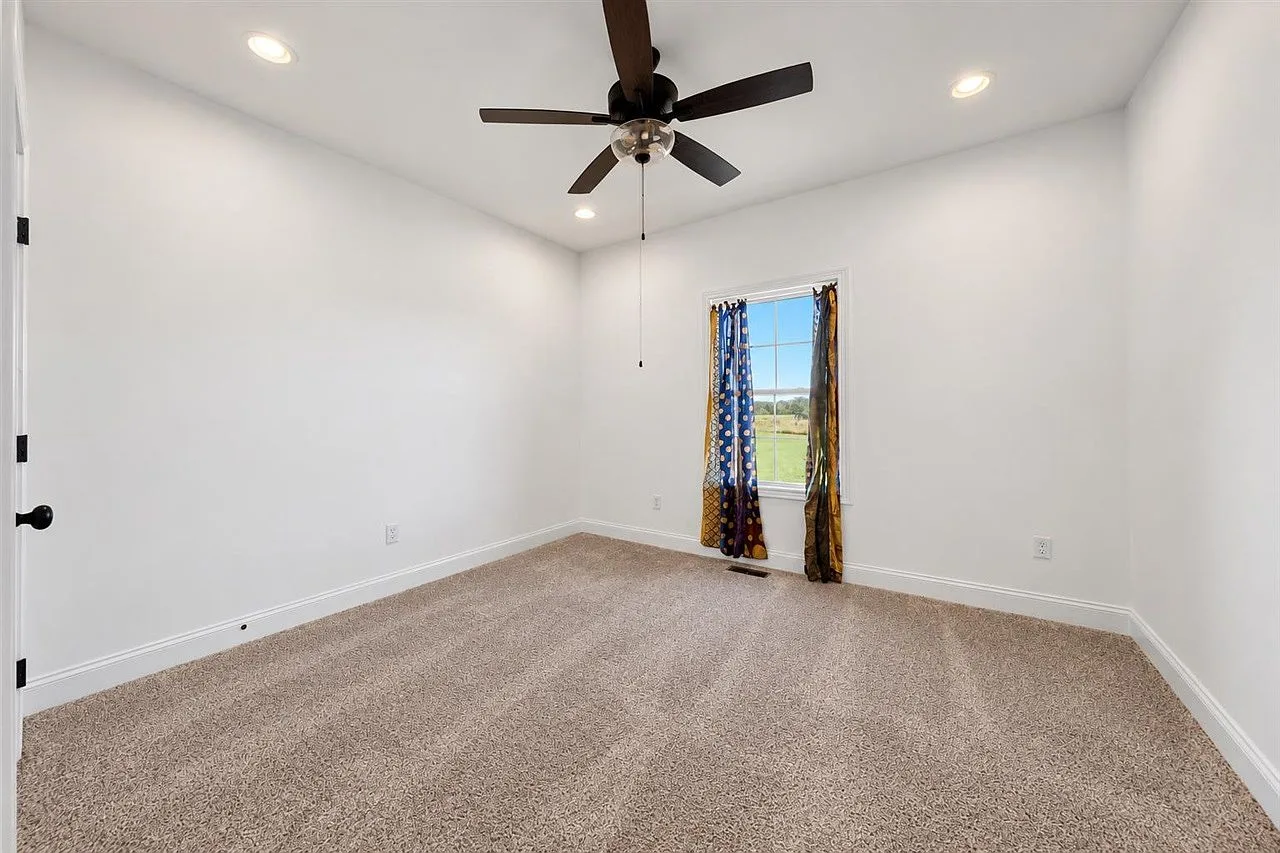 Secondary bedroom with carpet and natural light