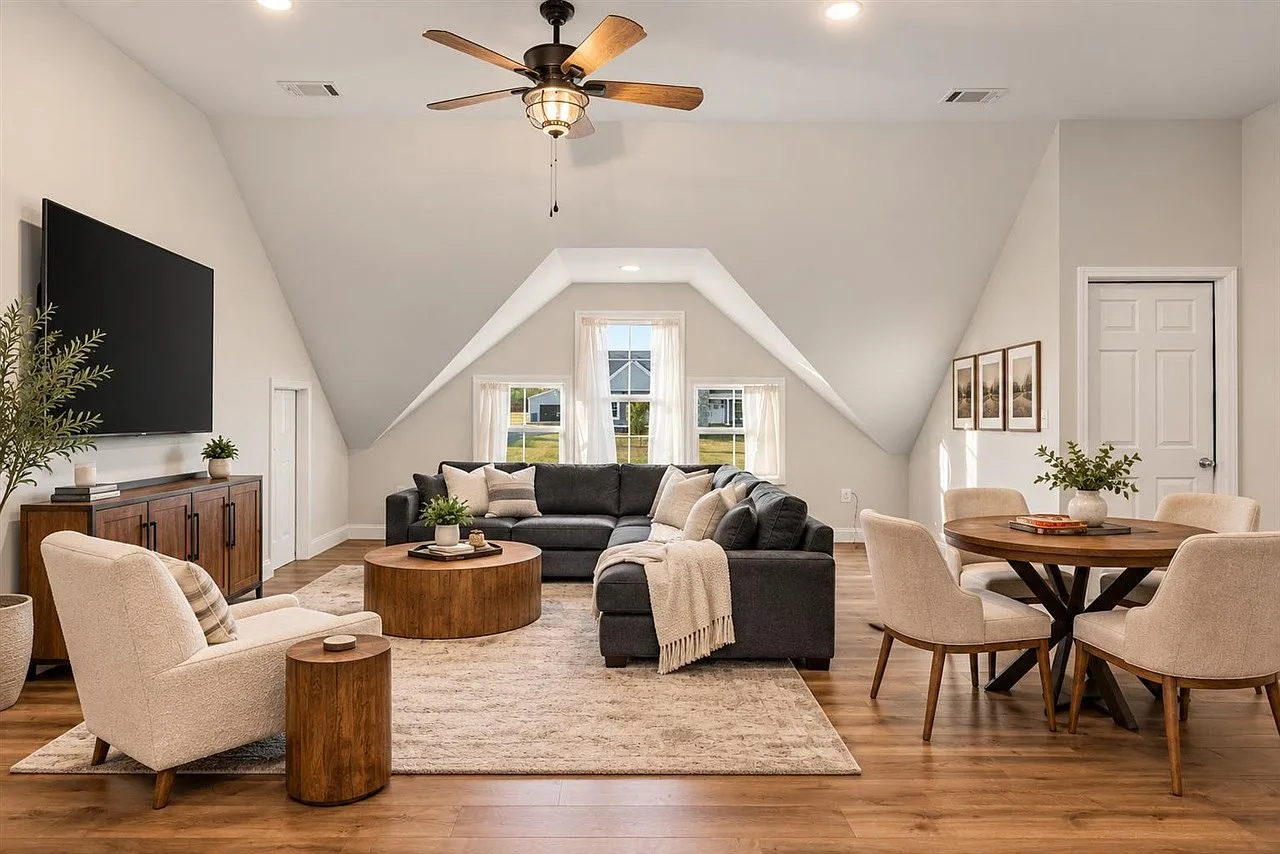 Enormous bonus room with vaulted ceilings, a media area, and space for a dining set