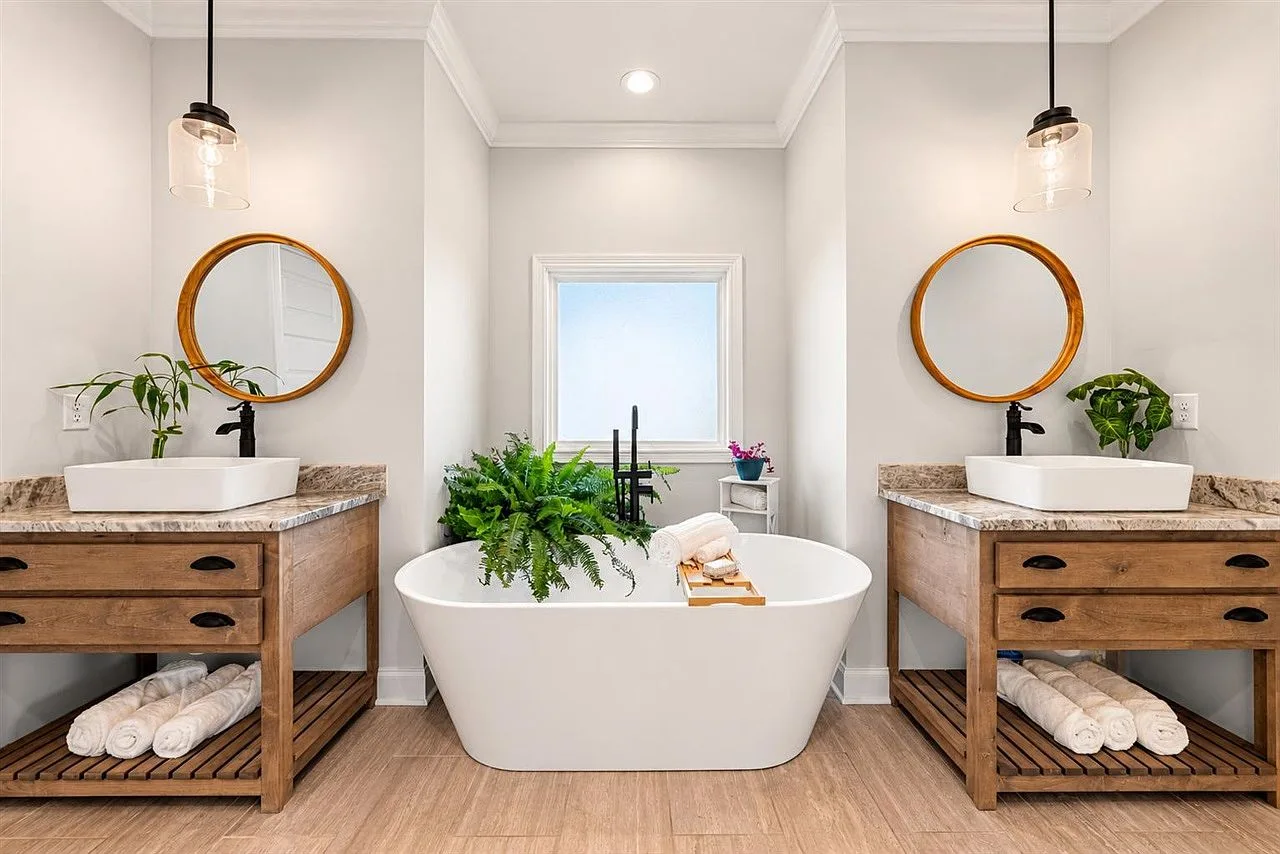 Primary bath dual vanities and freestanding tub with bright natural light