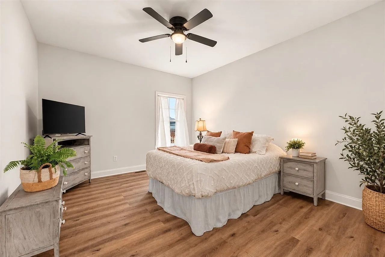Spacious primary bedroom with soft neutral finishes and generous floor space