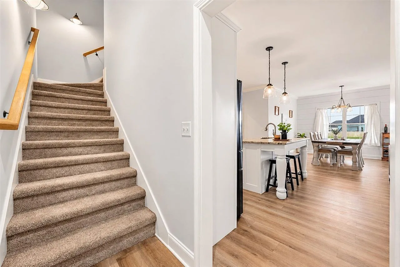 Staircase view down into the kitchen and dining area