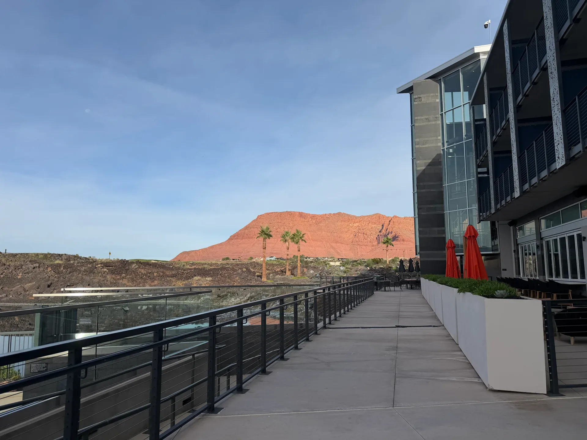 Modern terrace walkway at Black Desert with red rock mesa views beyond
