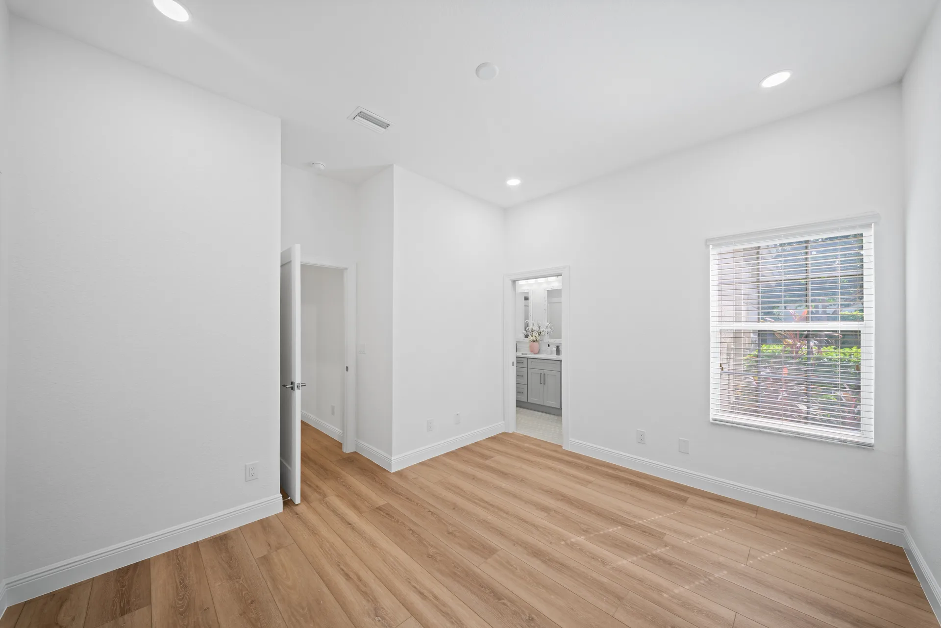 Bedroom interior with blinds and recessed lighting