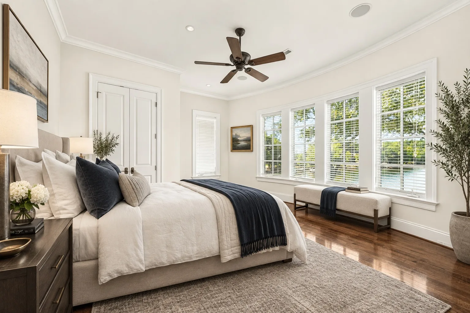 Master bedroom with large windows and lake views