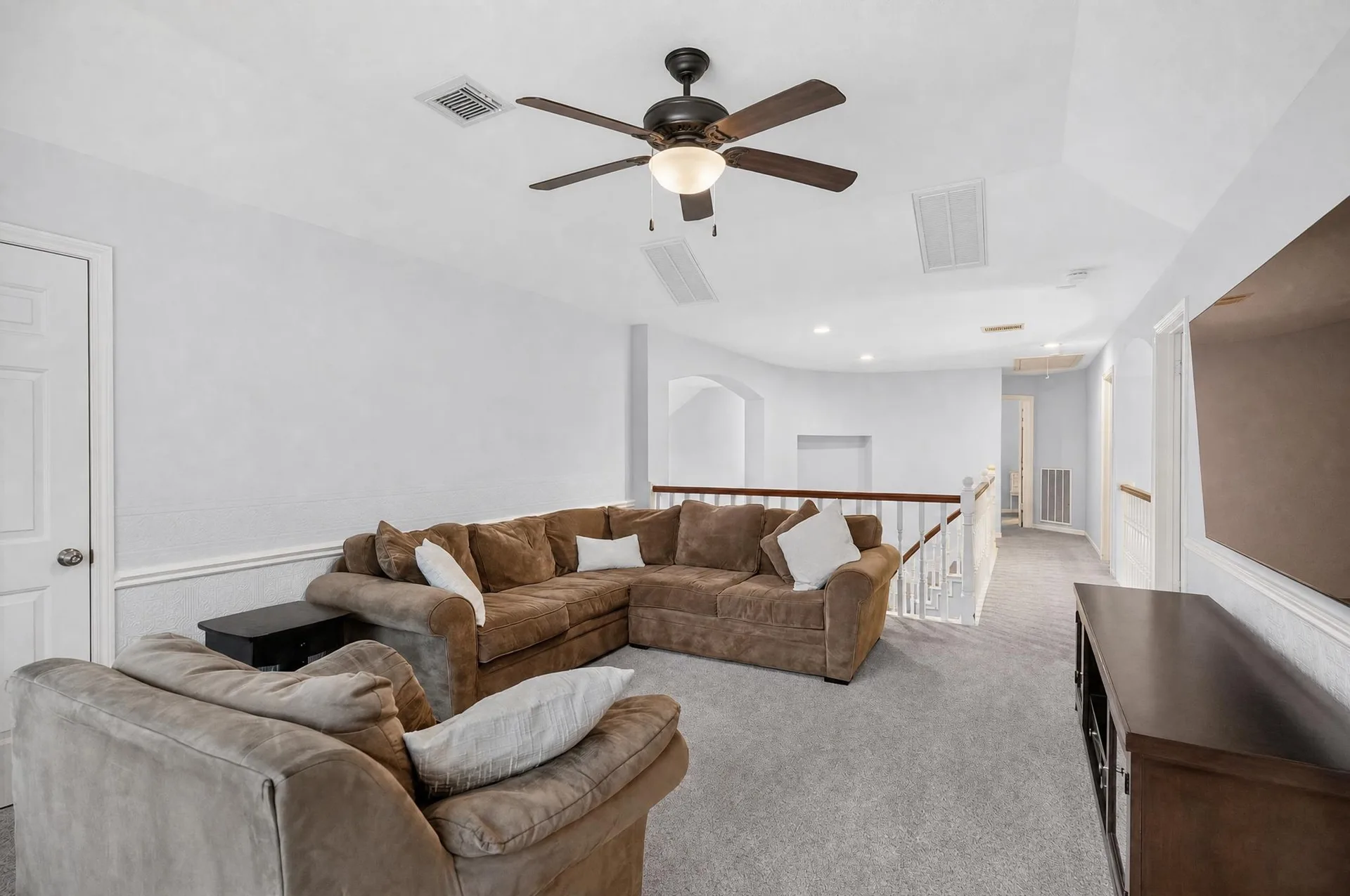 Upstairs game room with neutral carpet, ready for movie nights and play