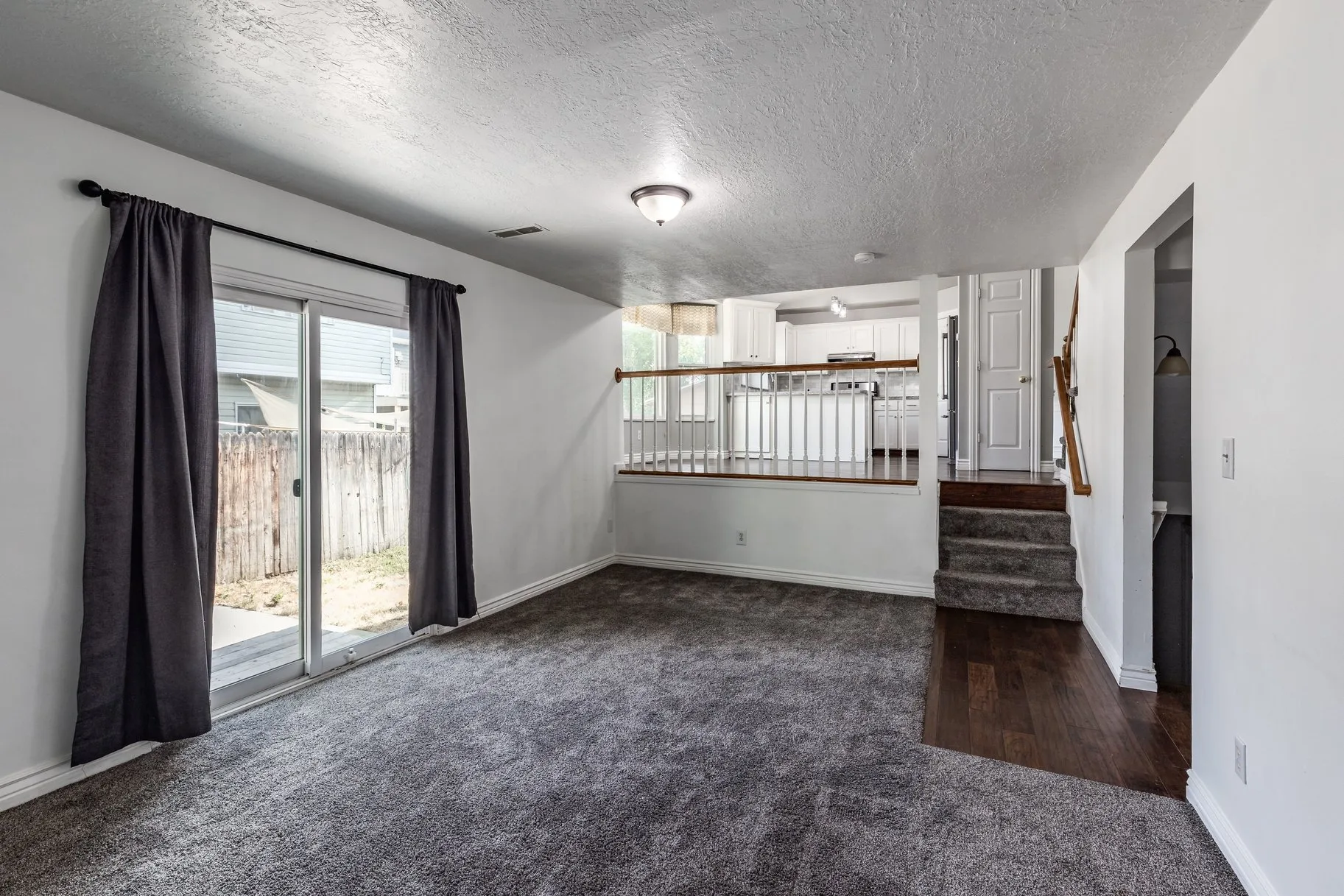 Living room with view to kitchen staircase
