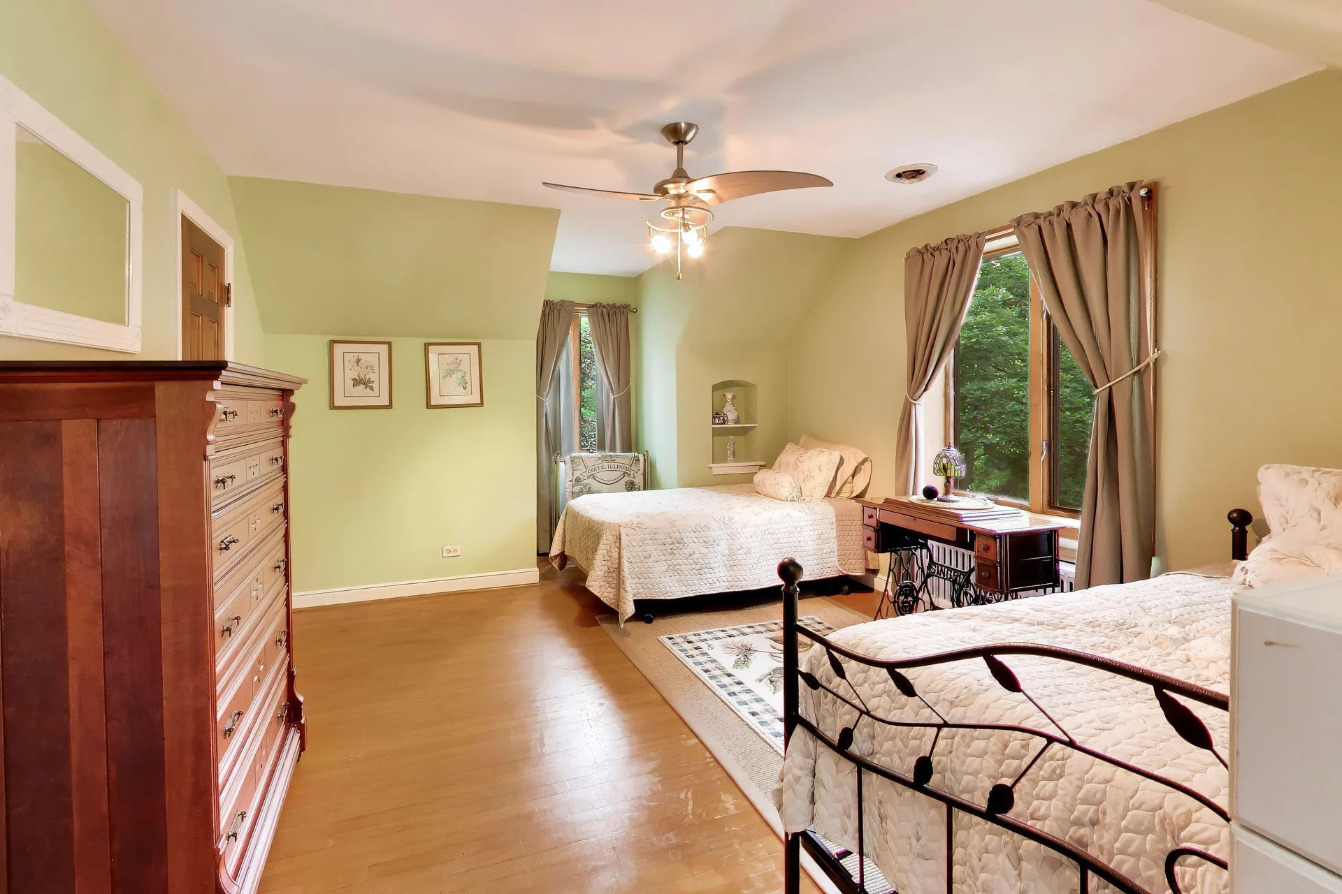 Secondary bedroom suite with green walls and wood floors