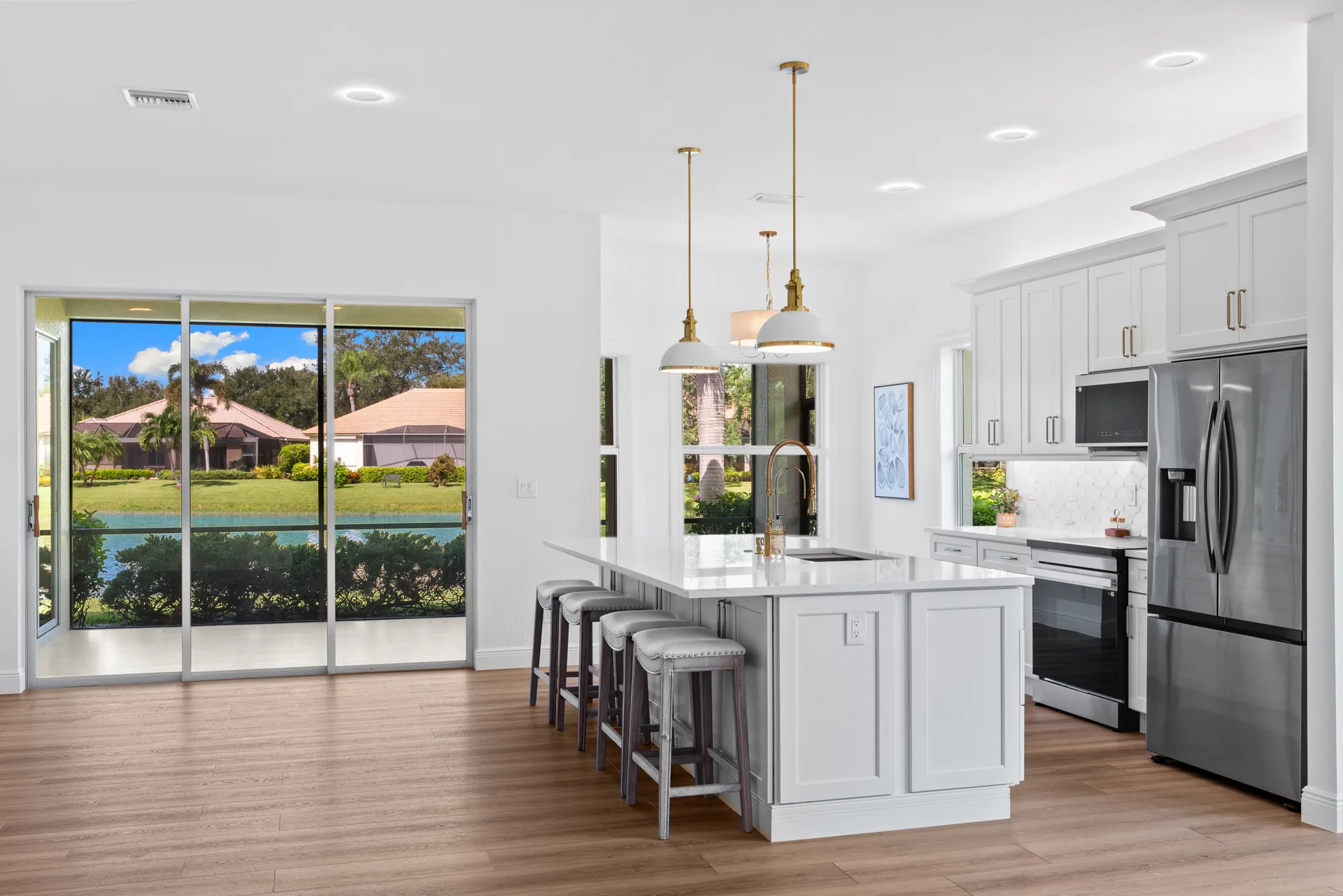Renovated kitchen overlooking lake at 878 Vistana Circle Naples Florida