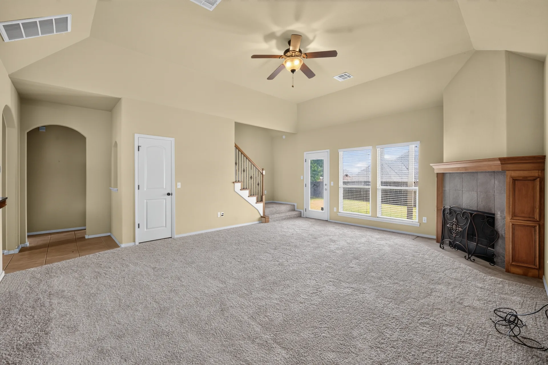 Great room with gas fireplace and tall windows