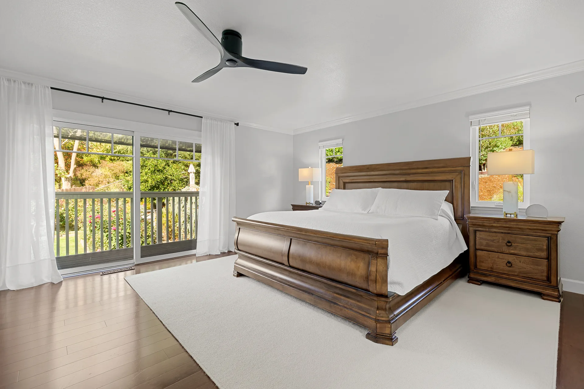 Primary bedroom with sliding glass doors opening to a private balcony