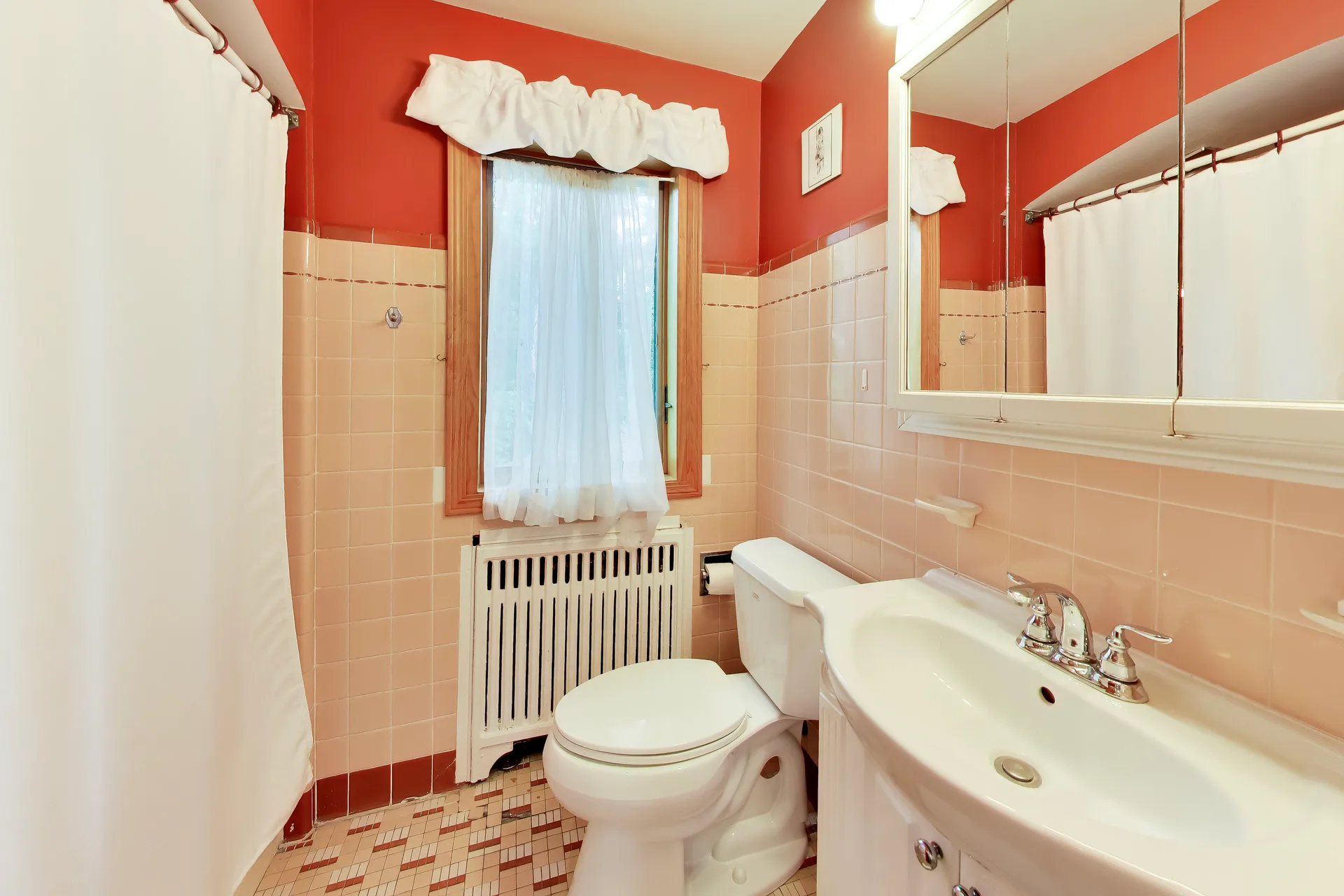 Bathroom with terracotta walls and beige tile wainscoting