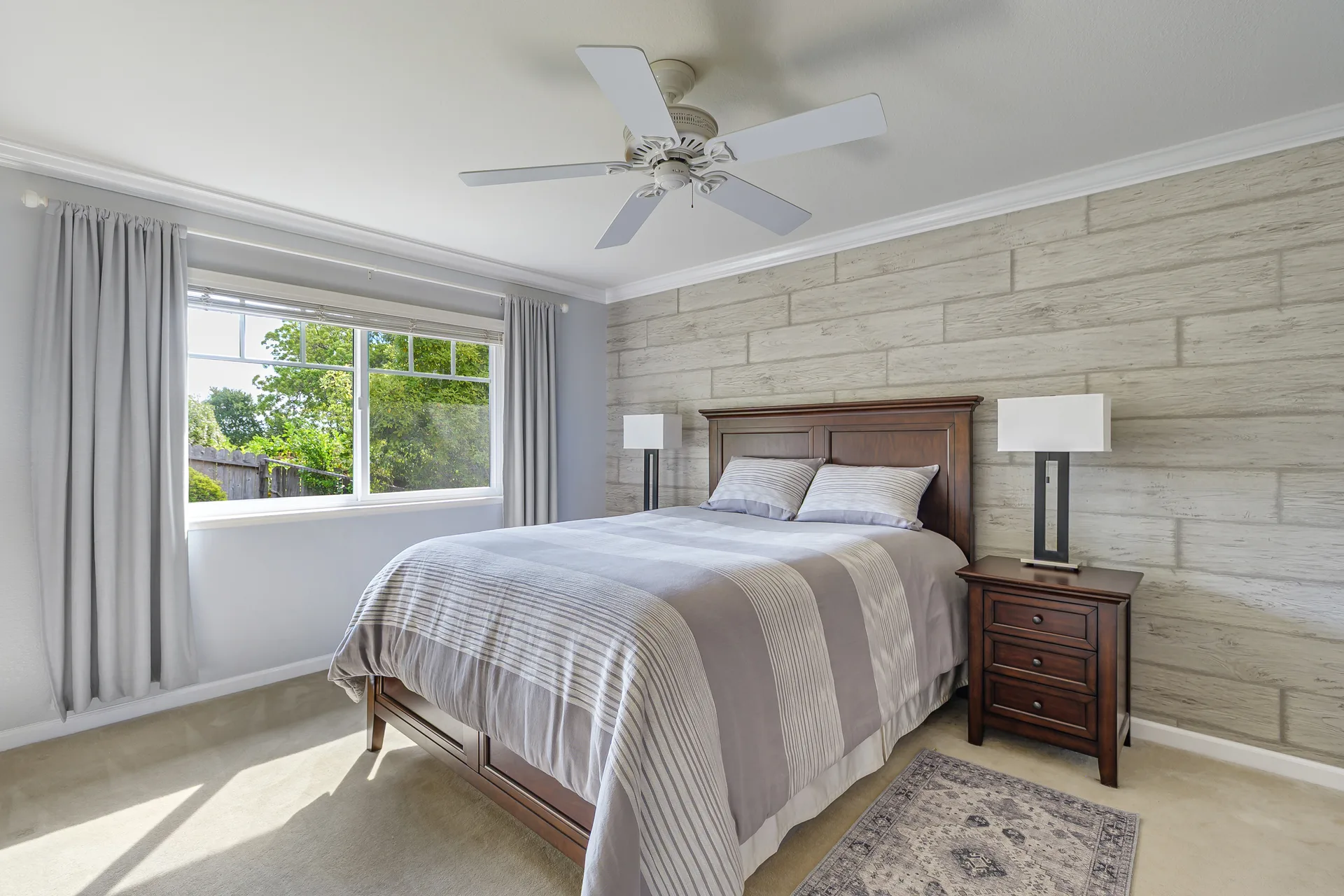 Secondary bedroom with a rustic wood-plank accent wall