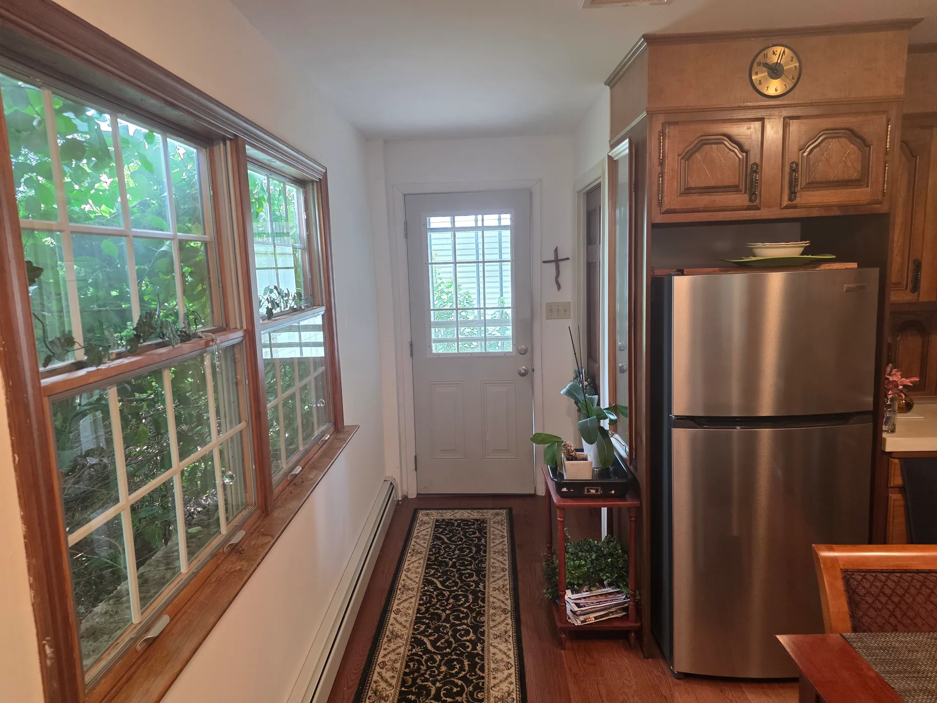 Kitchen entryway with natural daylight and wood-trim windows