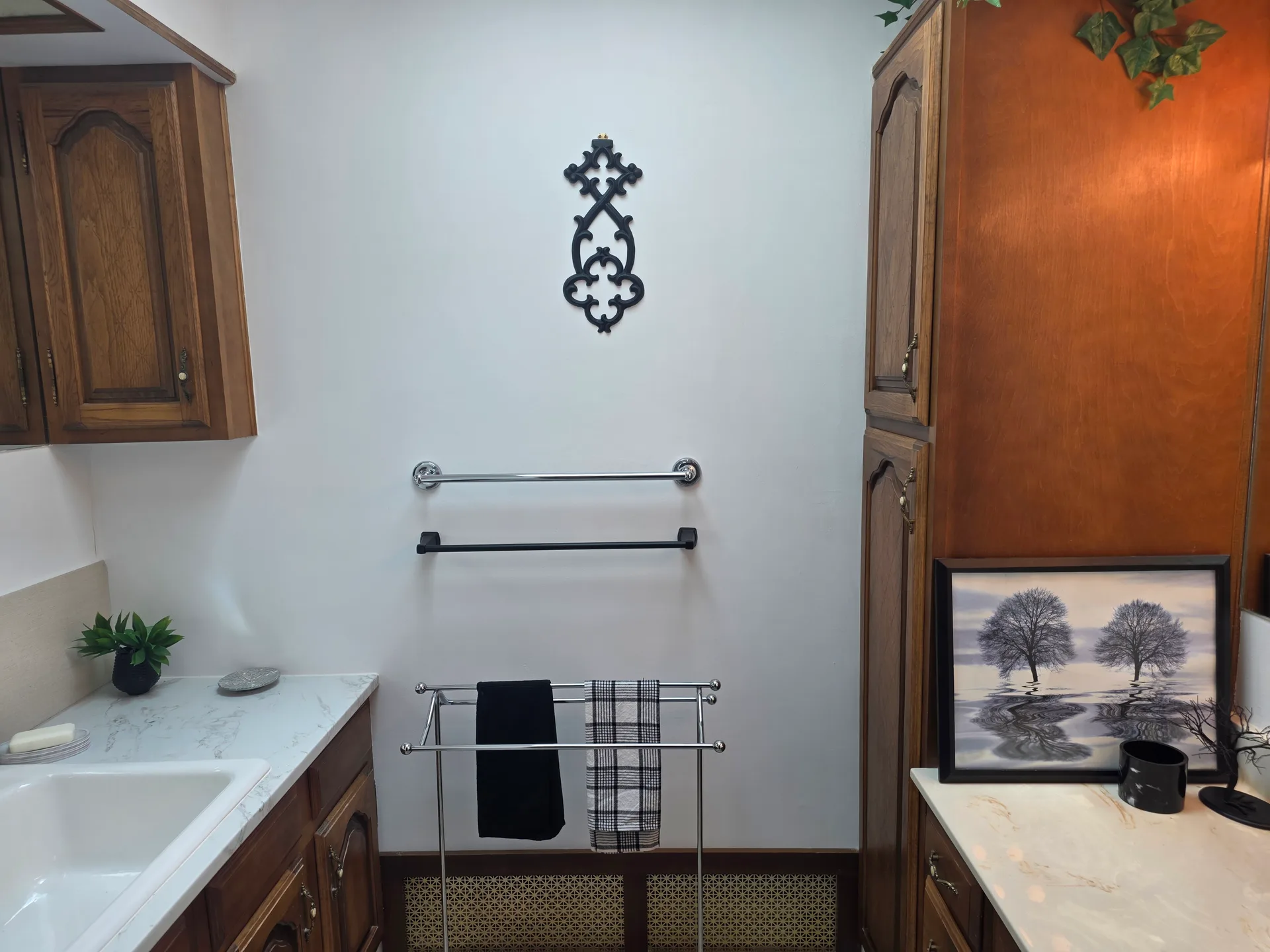 Bathroom vanity with wood cabinetry and light countertops