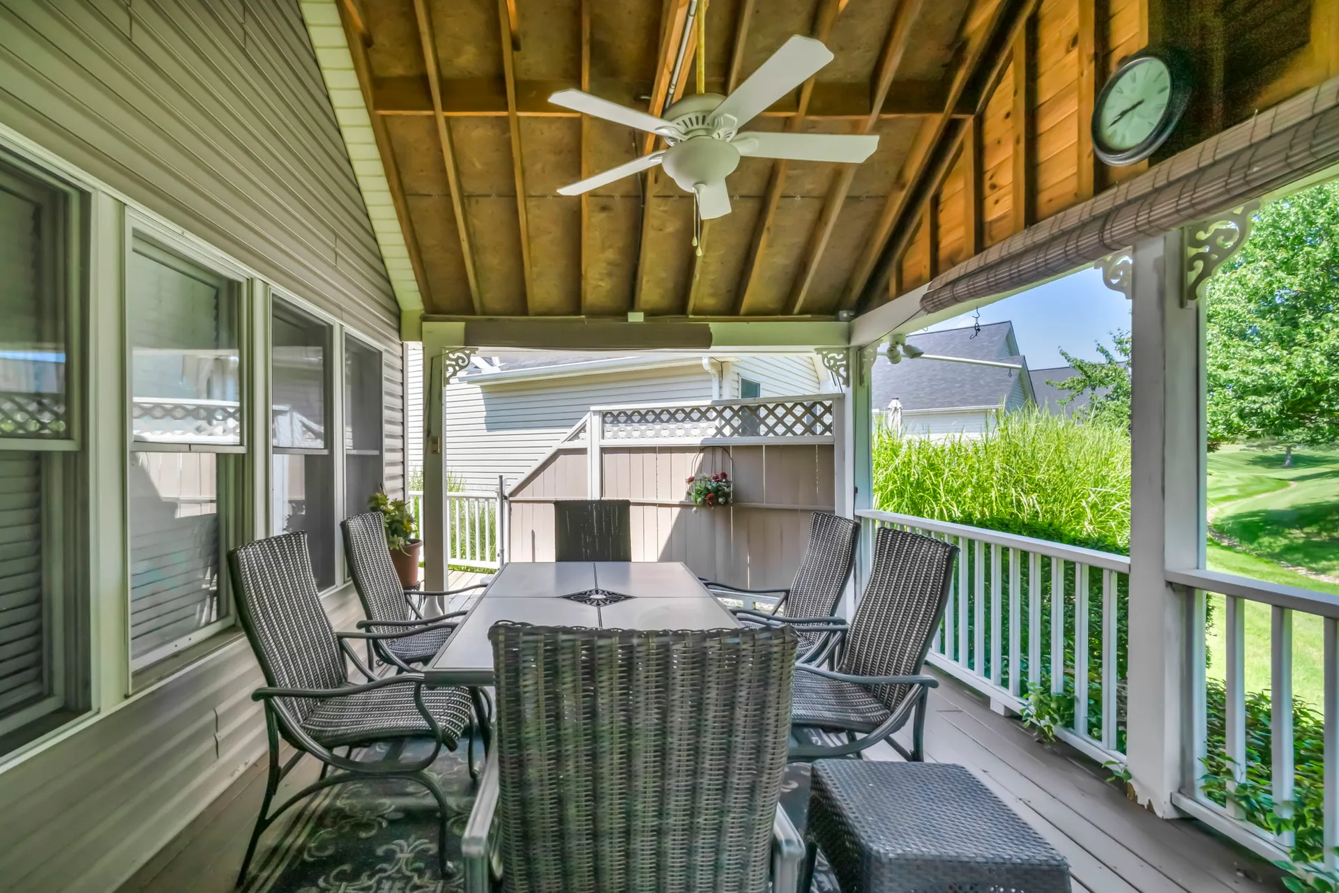 Covered deck with open-rafter ceiling and lattice privacy screen