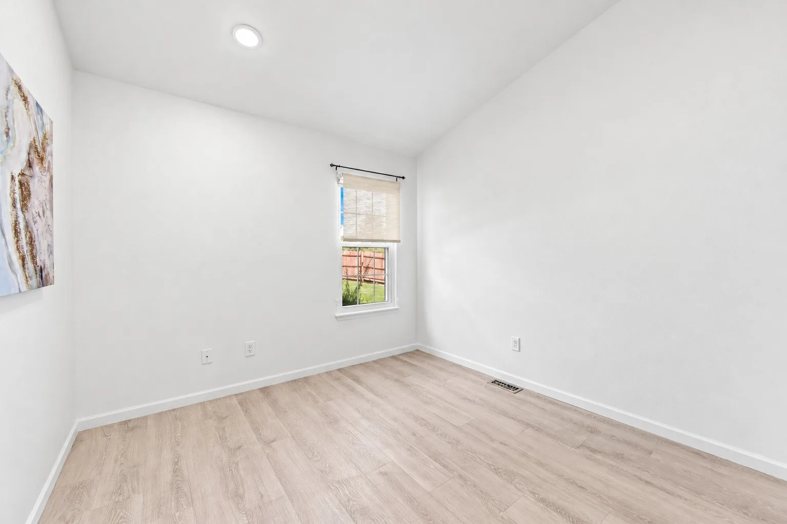 Guest bedroom with neutral finishes and natural daylight