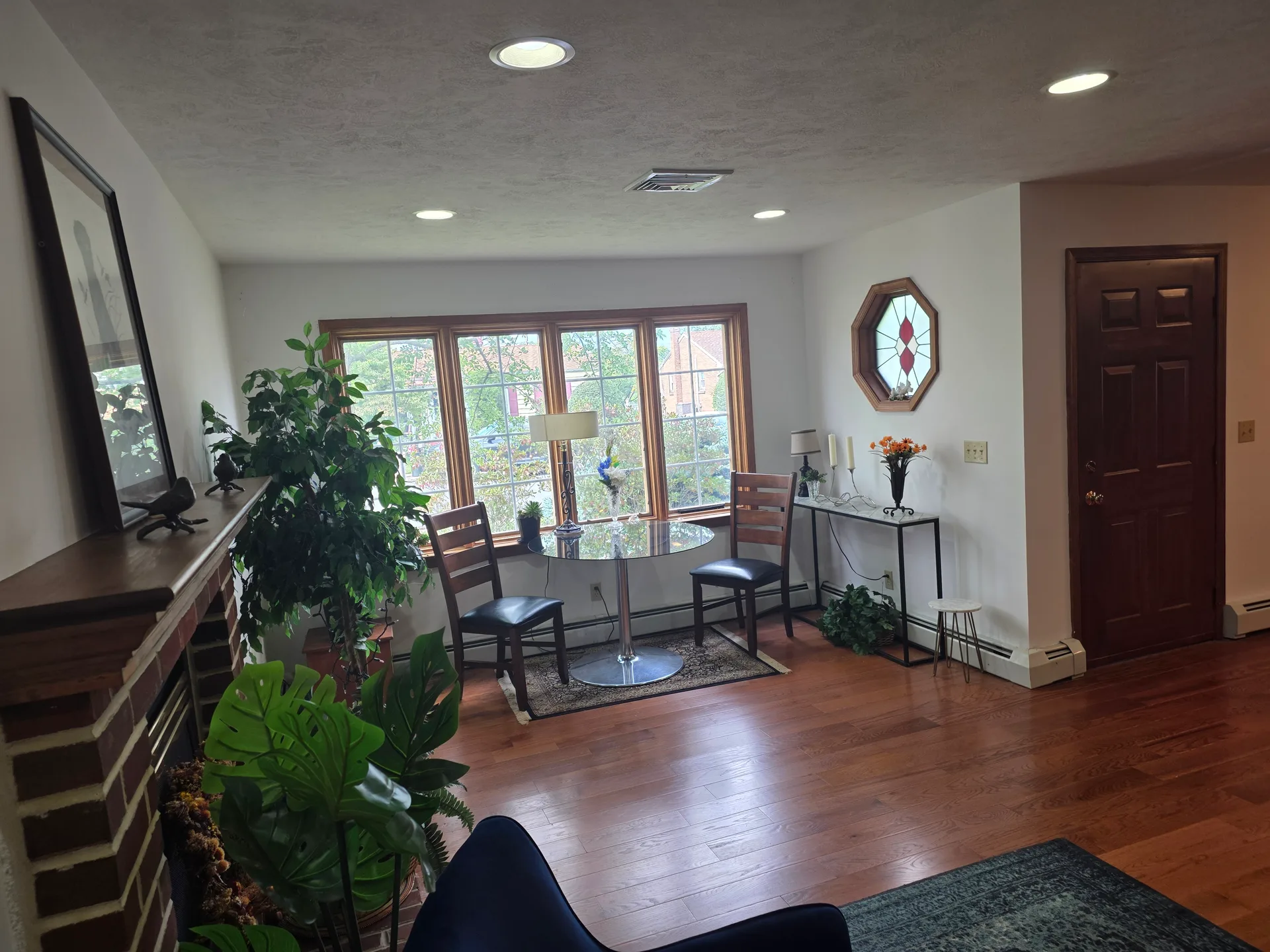 Living room with brick fireplace surround and recessed lighting