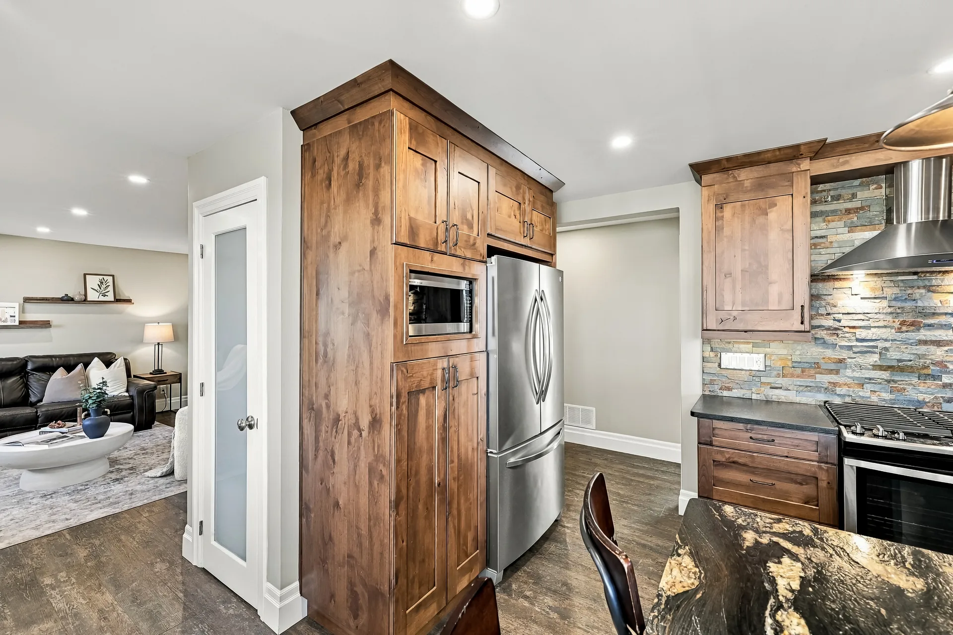 Kitchen view into the living room with island and full-size appliances