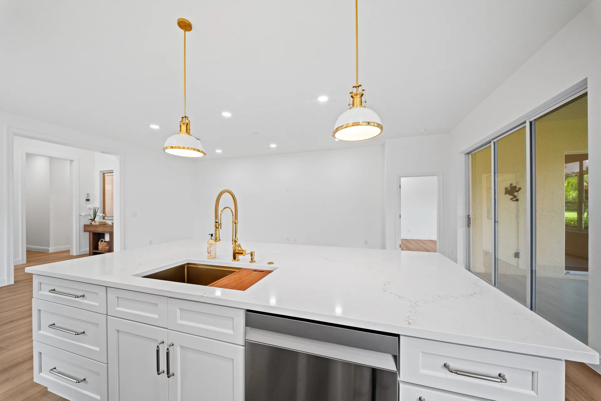 Kitchen island with white quartz waterfall countertop and gold hardware
