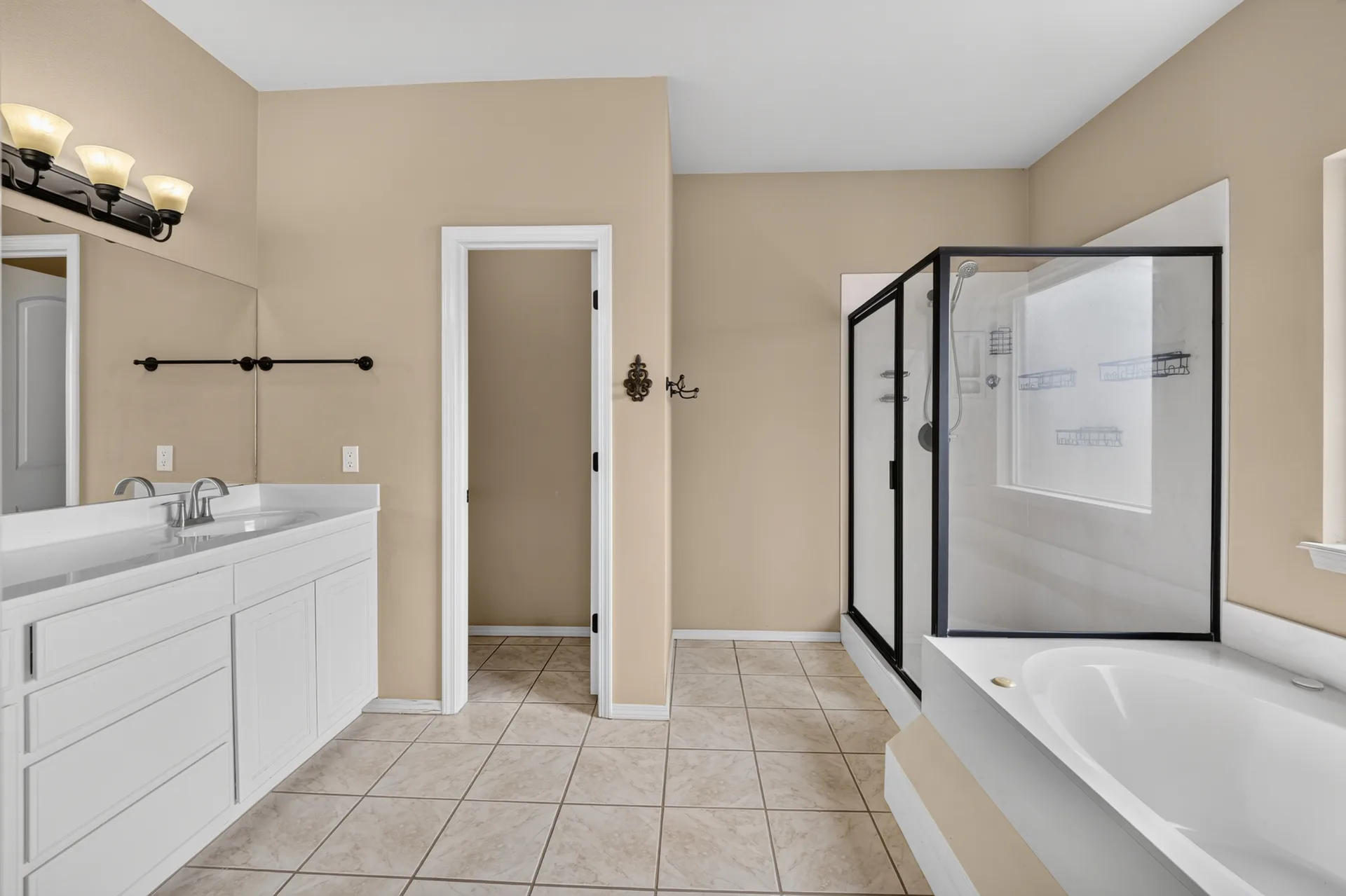 Primary bath with black-framed glass shower