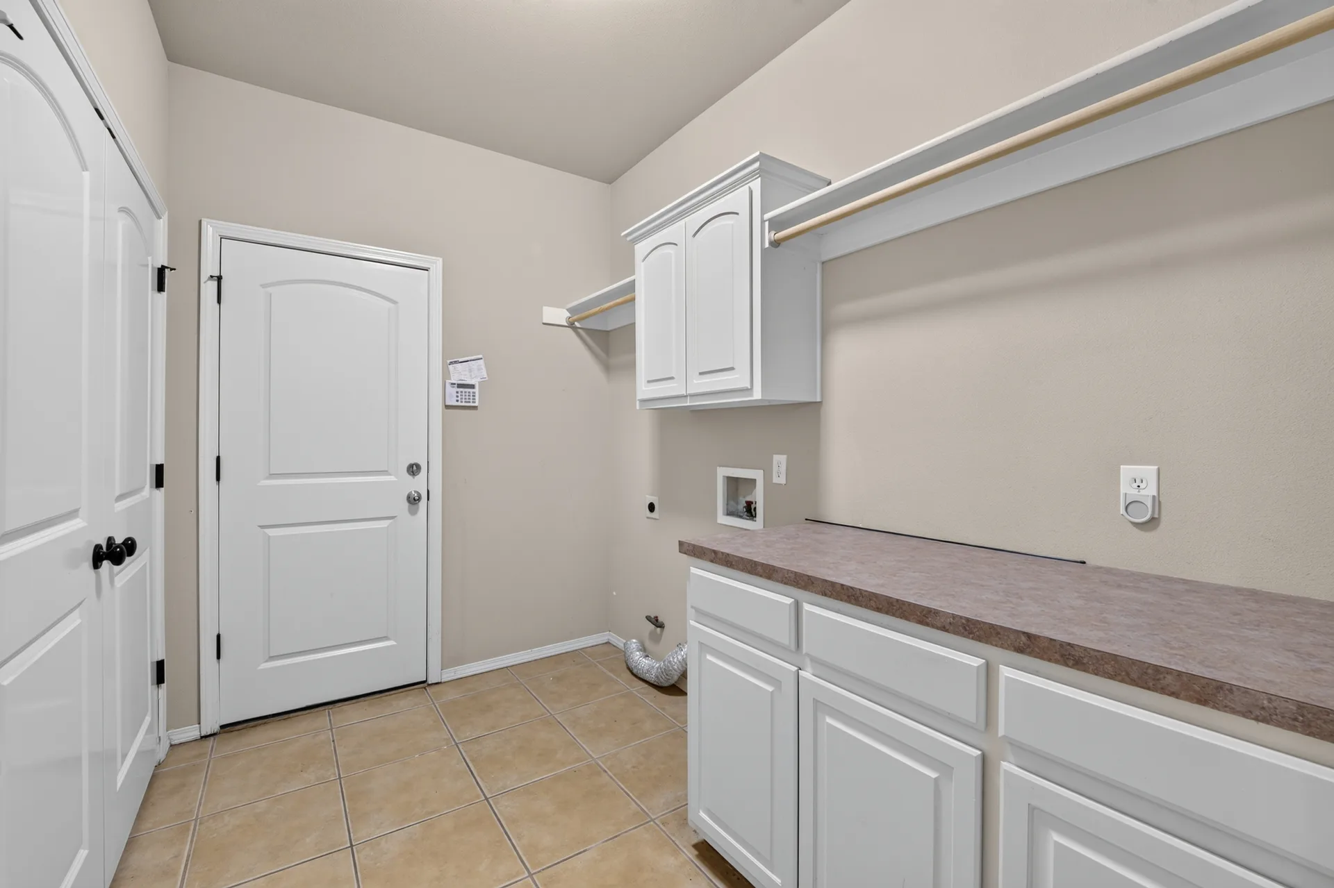 Utility room with cabinets and counter