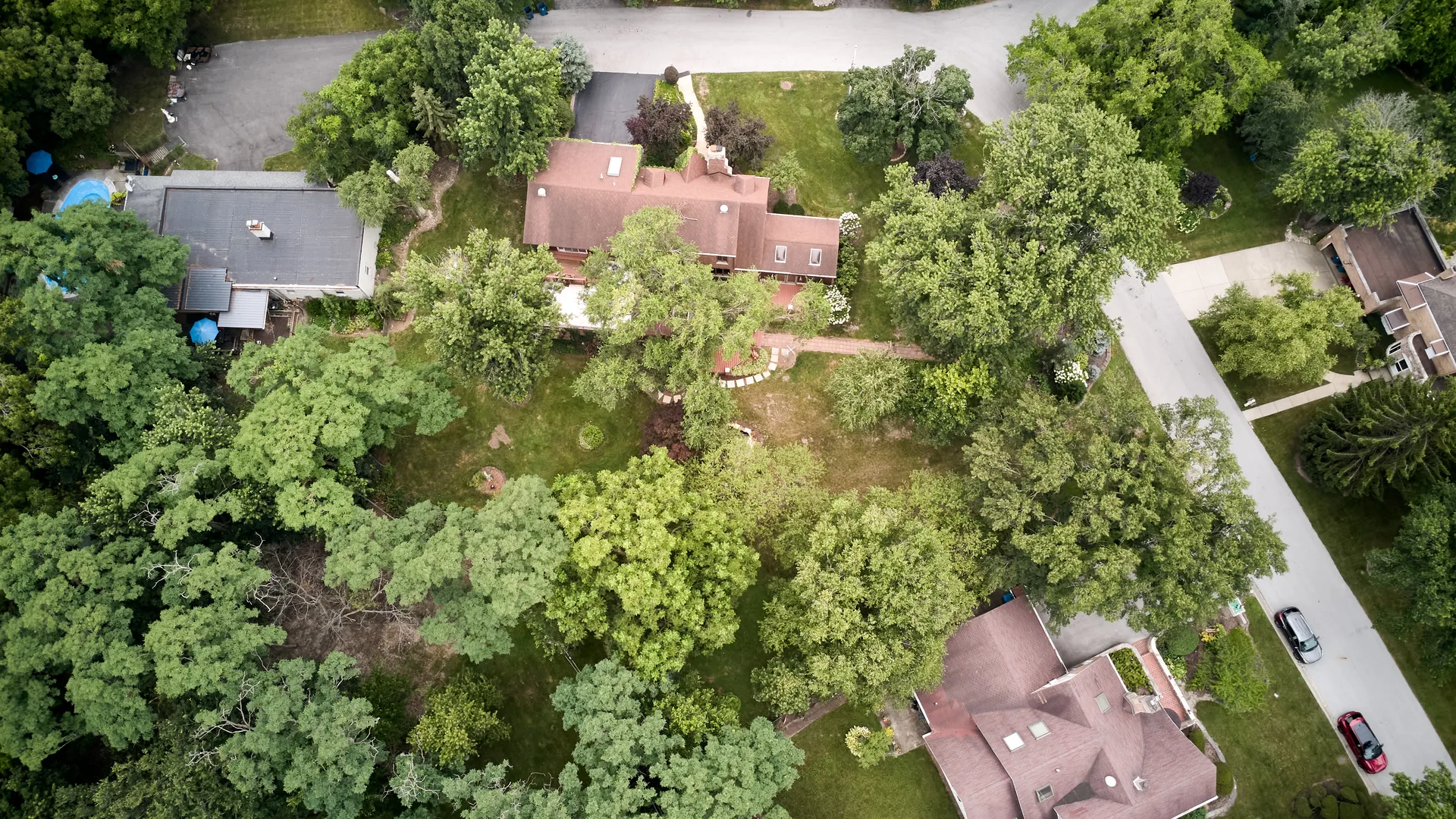 Aerial view of the wooded lot and roofline