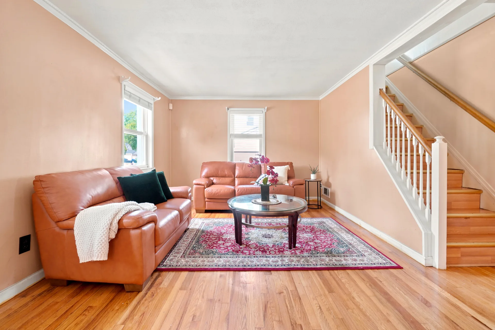 Living room at 50 Heather Ln with wood flooring and white staircase railing