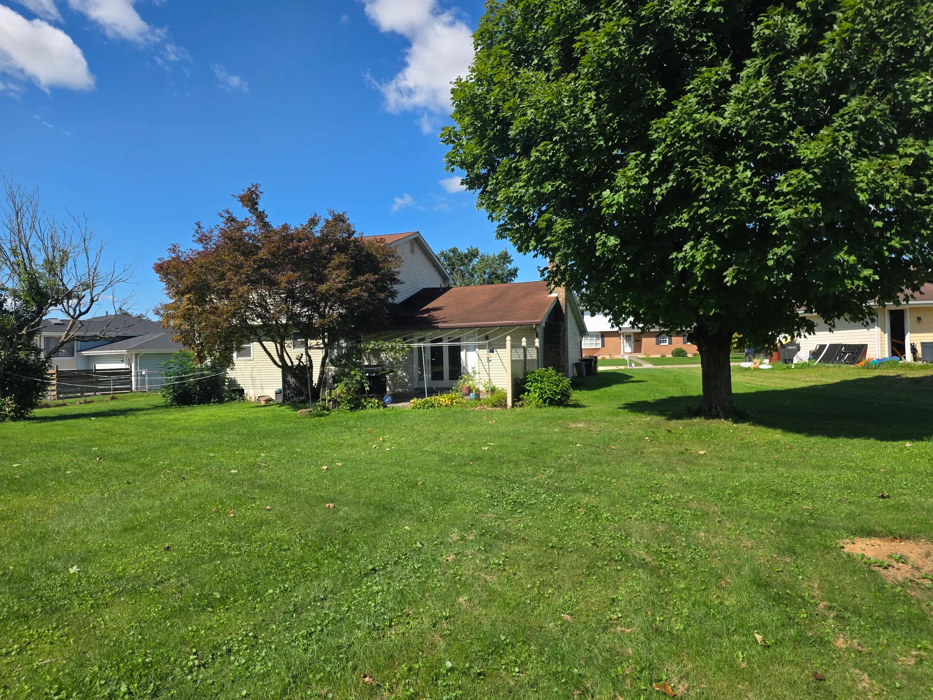 Rear patio and spacious yard behind the Colonial at 4420 Phillip Street