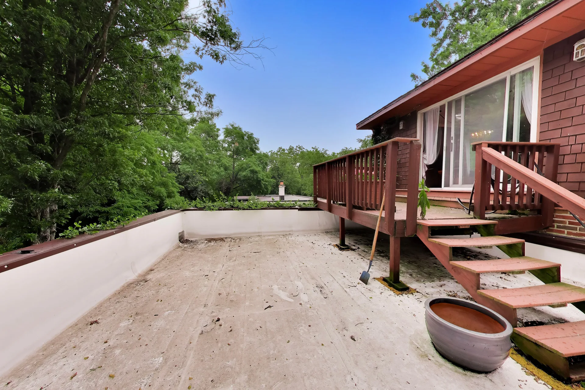 Patio and raised deck at the rear of the house