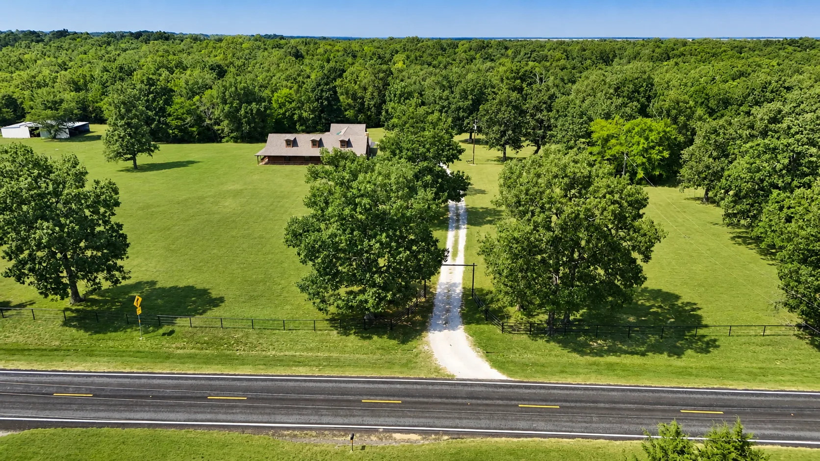 Aerial view of the 4.5-acre log cabin property in Arthur City, Texas