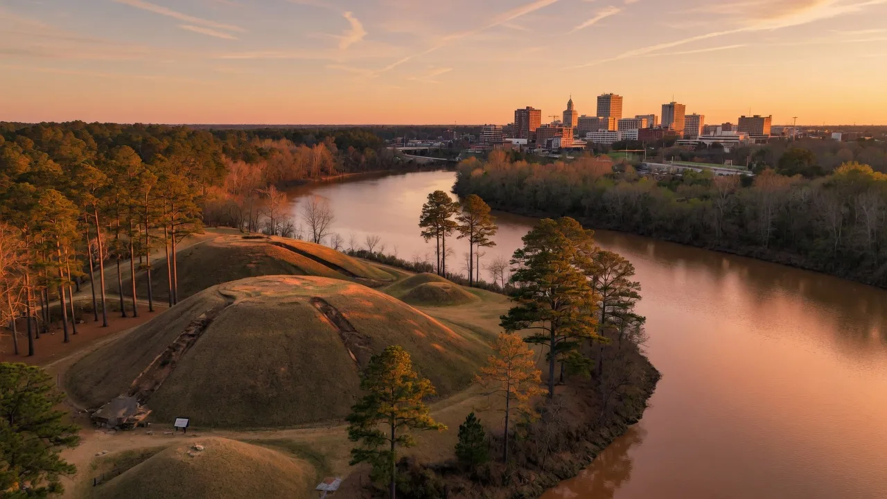 Ocmulgee River curving through central Georgia near Macon with the earthen mounds of Ocmulgee Mounds National Historical Park at golden hour
