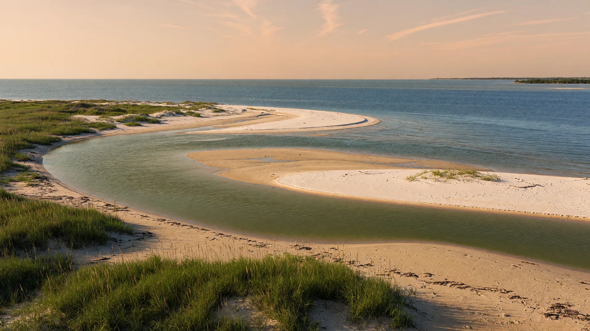 A river mouth meeting the Gulf of Mexico on the Texas coast