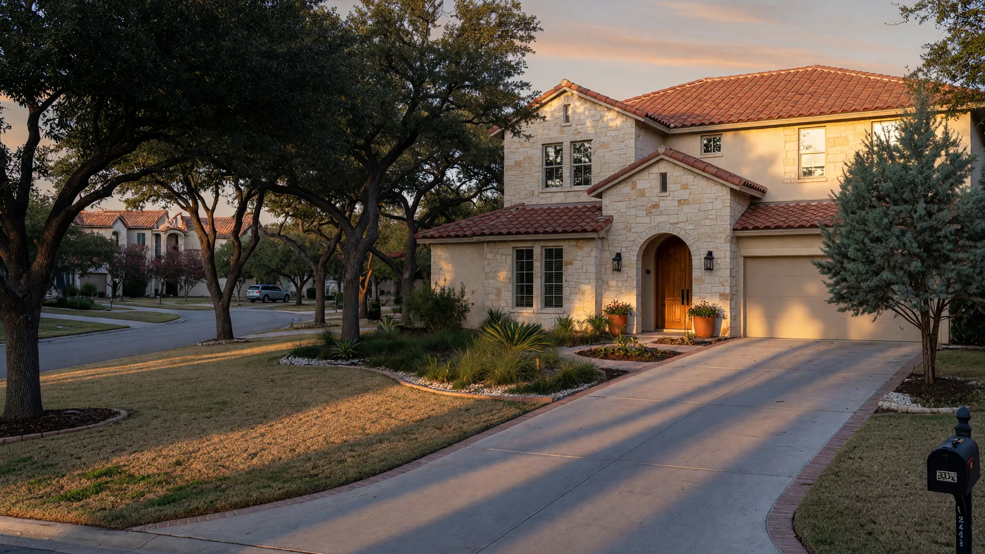 A newer Stone Oak home with limestone and stucco walls, a tile roof, and manicured lawn at golden hour, the kind of far north San Antonio house a home inspector in Stone Oak inspects