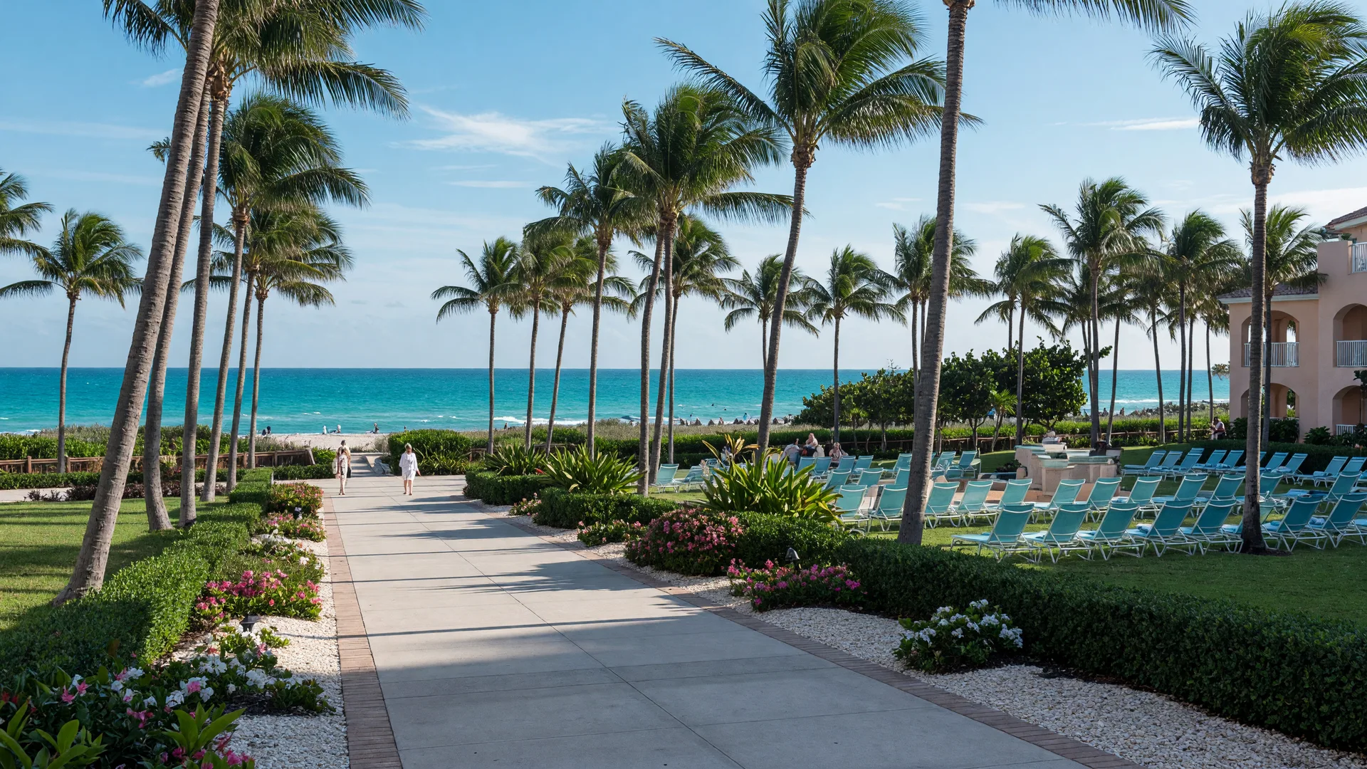 The palm-lined resort grounds at The Diplomat Beach Resort in Hollywood, Florida, with the Atlantic Ocean and white sand visible beyond the walkway