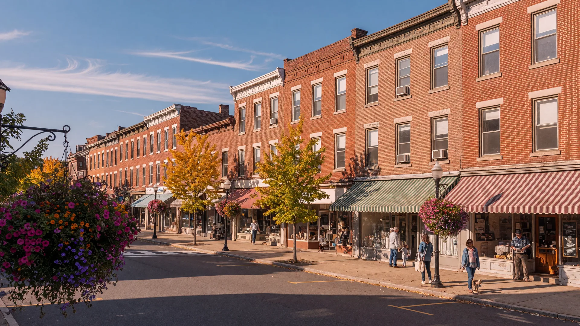 A small-town Lehigh Valley main street in mid-September with brick storefronts and early fall color on the trees
