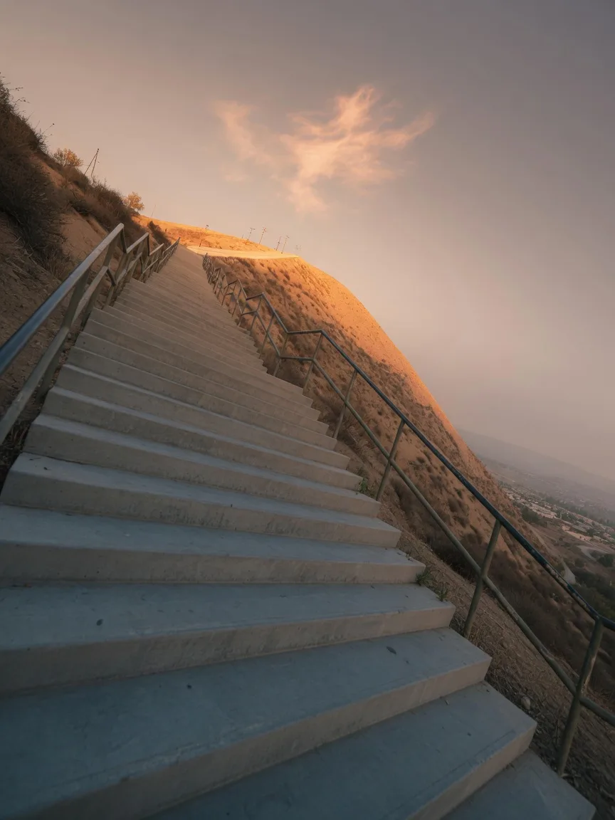 The Central Park stairs in Santa Clarita climbing toward a golden ridge-top at sunrise on Patriot Day morning
