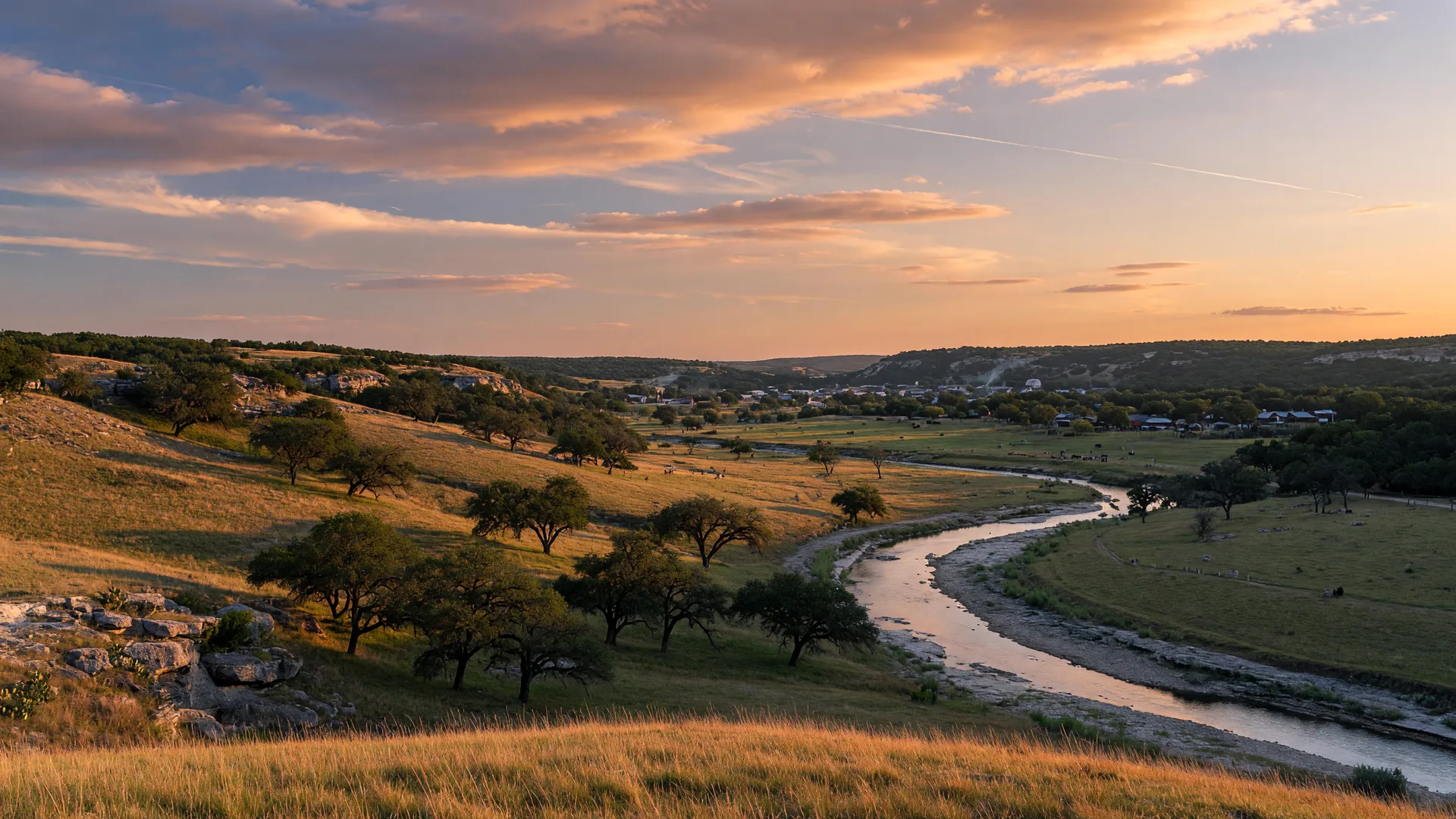 Rolling hills and live oak trees in the Texas Hill Country at late afternoon