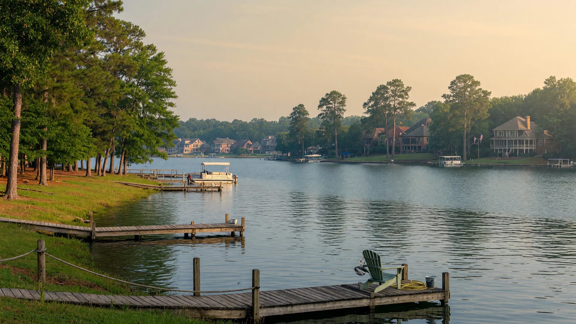 Lake Norman shoreline on a calm summer morning with a wooden dock extending into the water