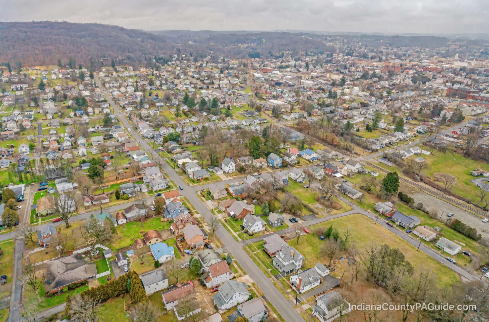 Aerial view of Indiana, PA showcasing the town's residential areas and surrounding hills