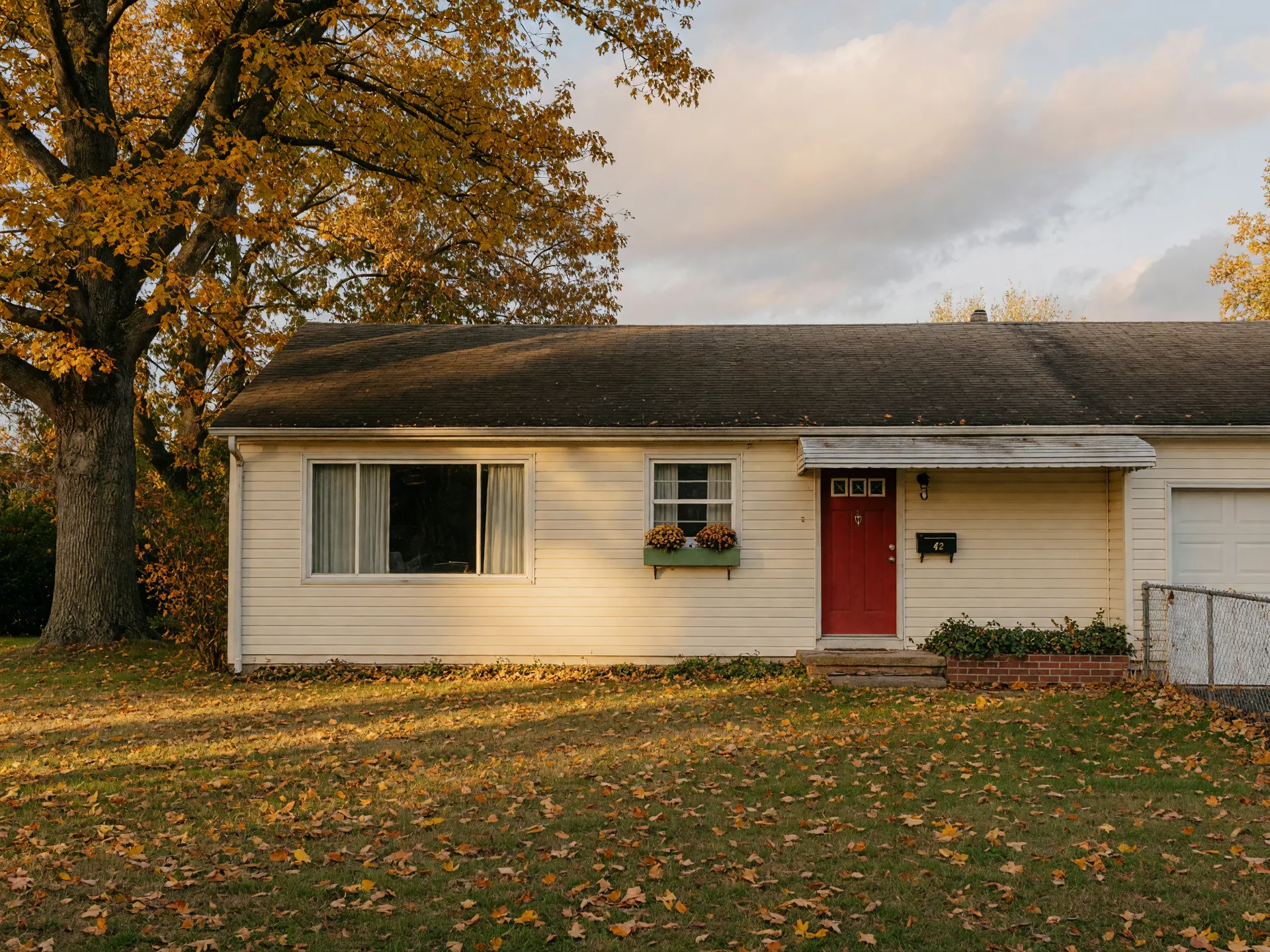 A classic mid-century ranch home in a Delran neighborhood with golden October leaves on the lawn