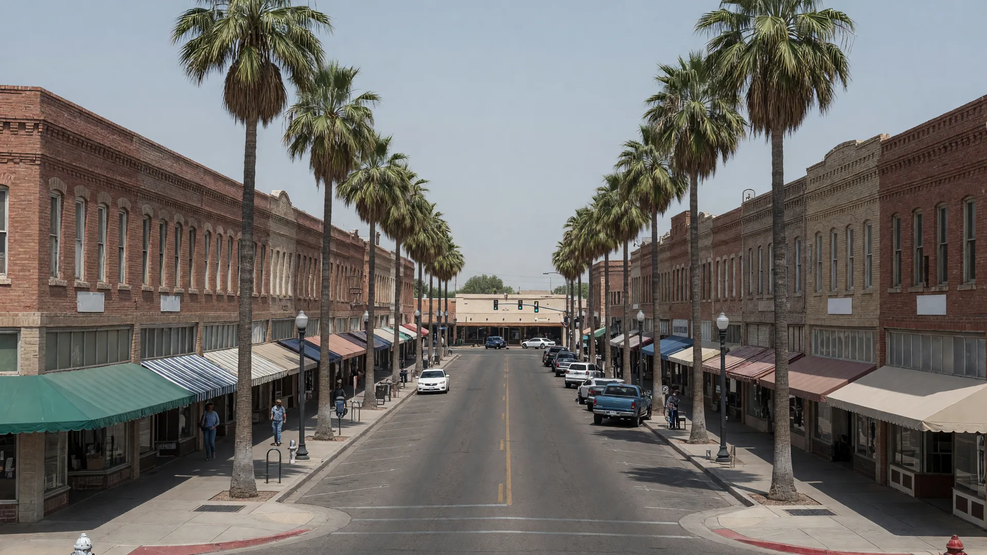 Downtown Mesa Main Street at golden hour with the Mesa Arts Center and palm-lined streetscape