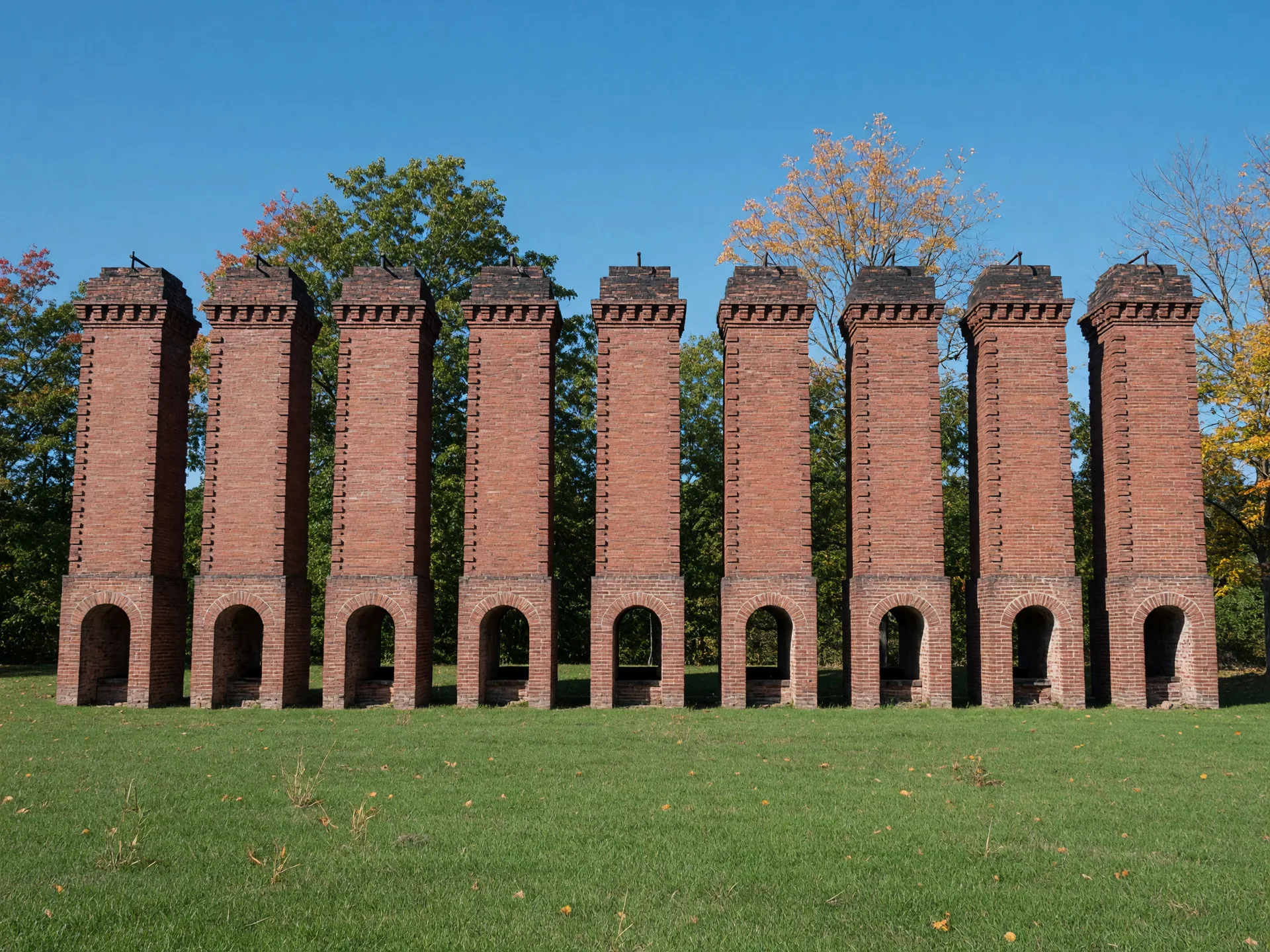 Nine tall red-brick Coplay Cement Kilns in a row at Saylor Park in Coplay, Pennsylvania, on a clear autumn afternoon
