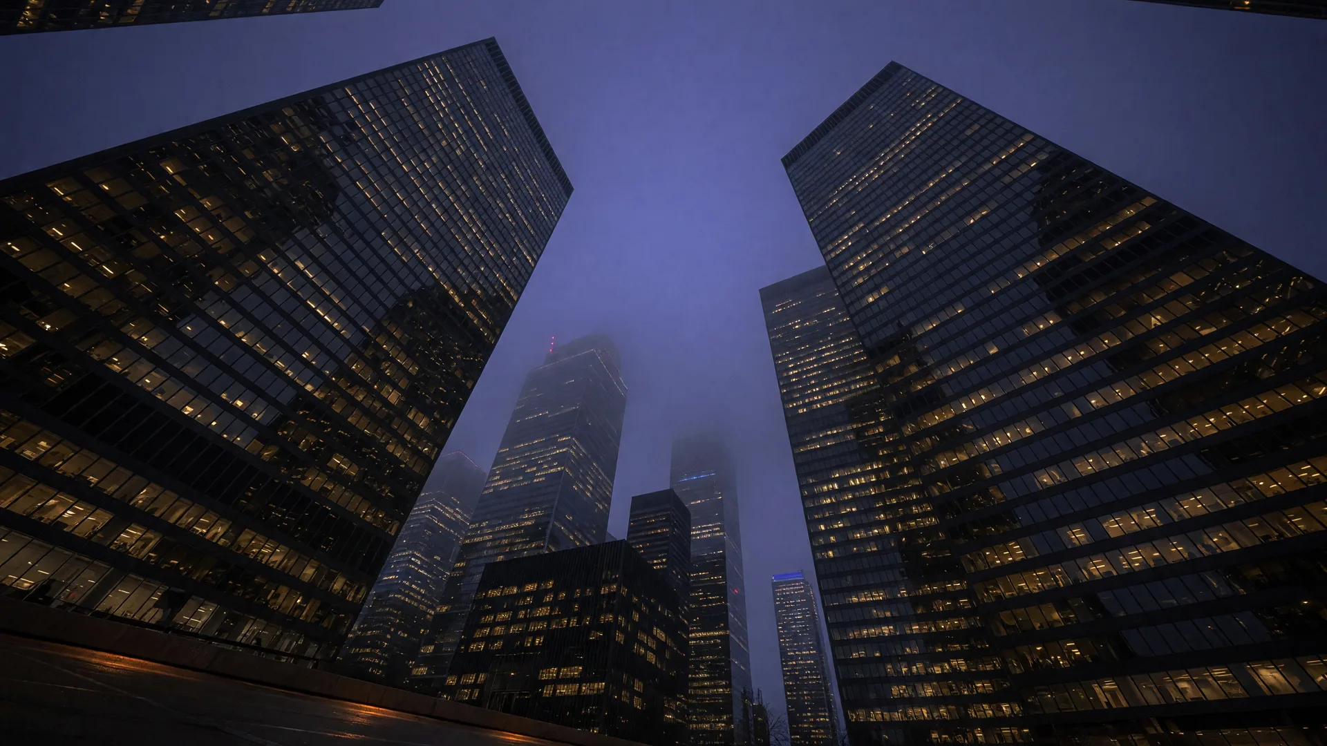 Modern city towers at dusk representing the 2026 brokerage consolidation wave and the opportunity it creates for agents who own their business